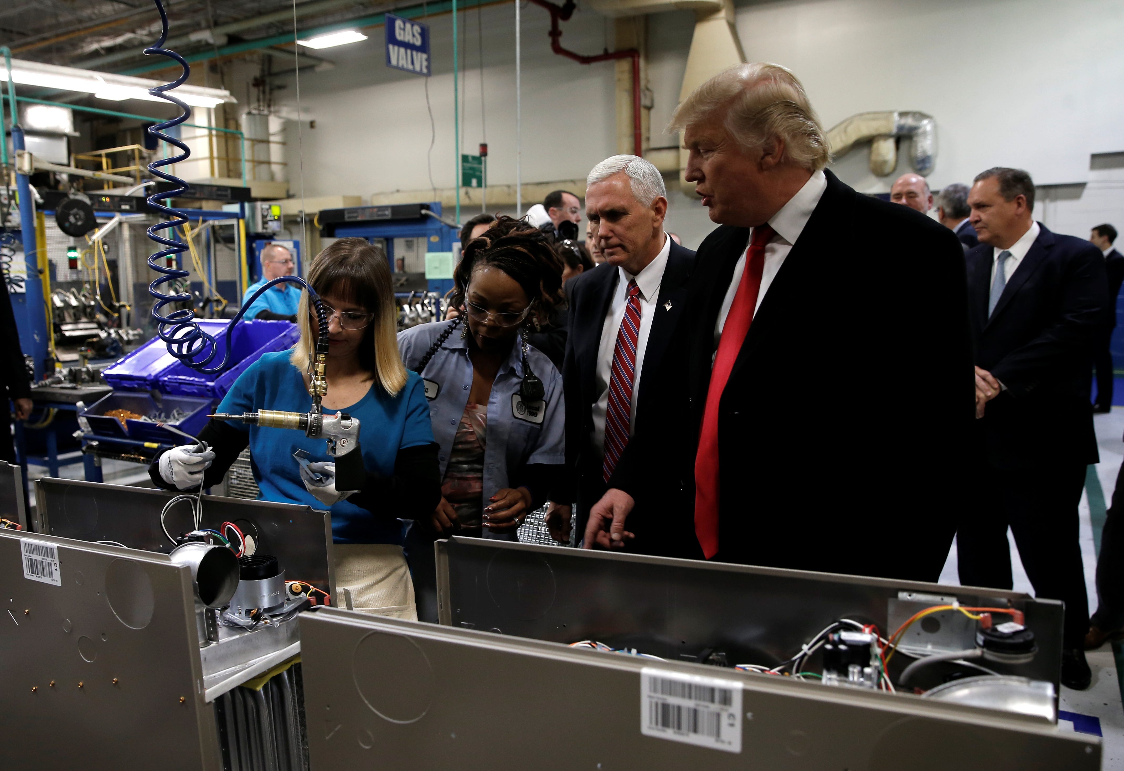 Donald Trump tours a Carrier factory with Greg Hayes, CEO of United Technologies (L) in Indianapolis