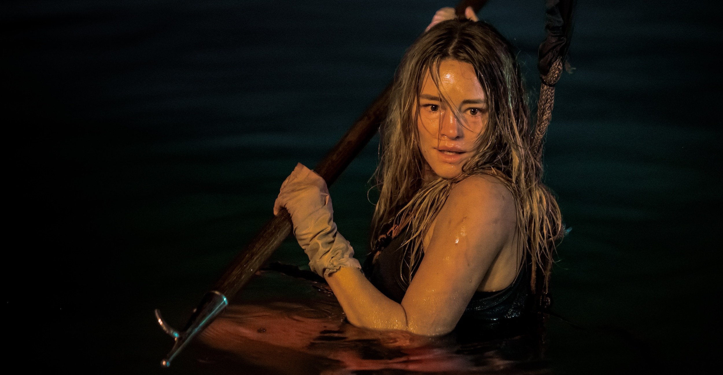 Zephyr (Hassie Harrison) holding a spear in Dangerous Animals