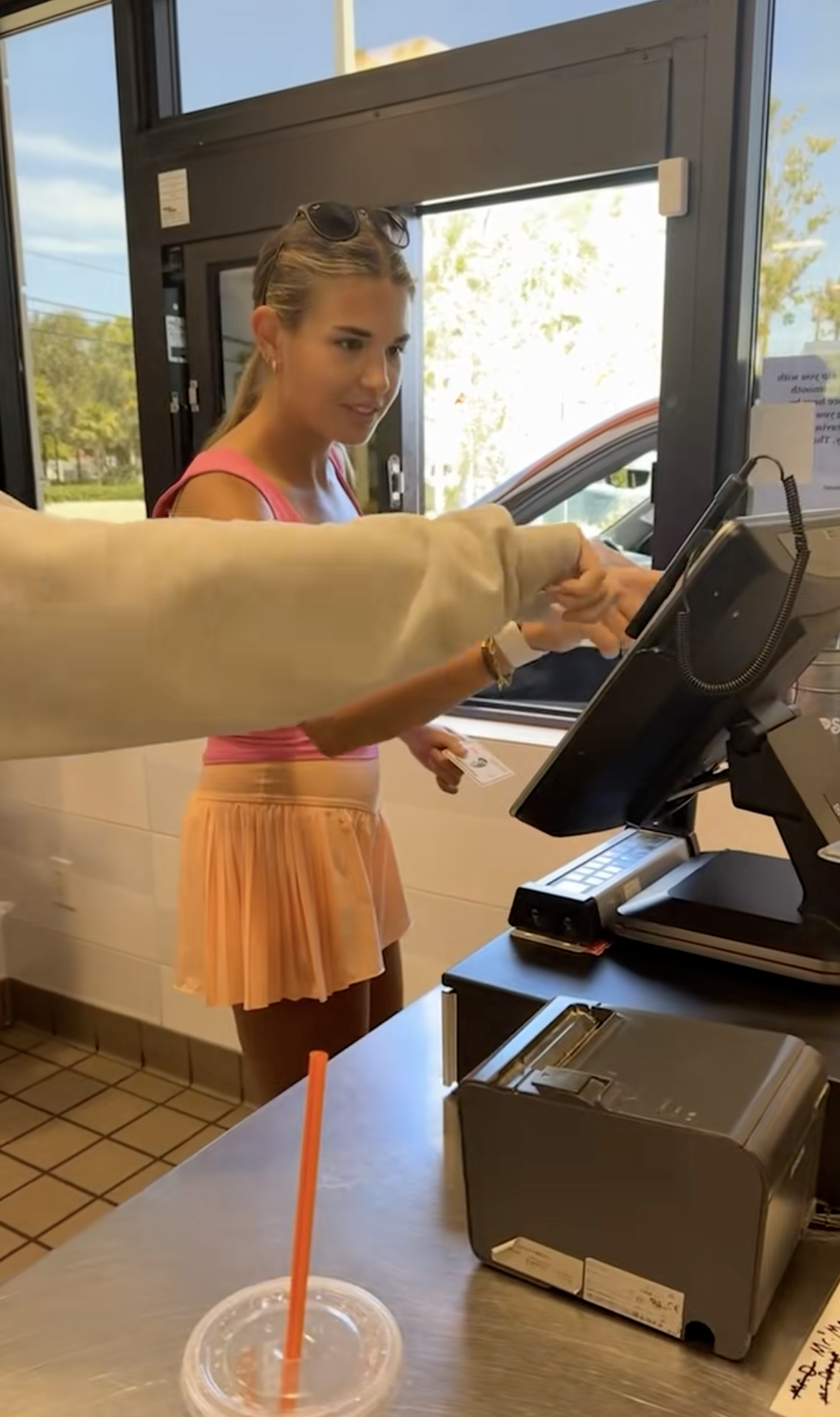 Kai Trump at a drive thru window. 