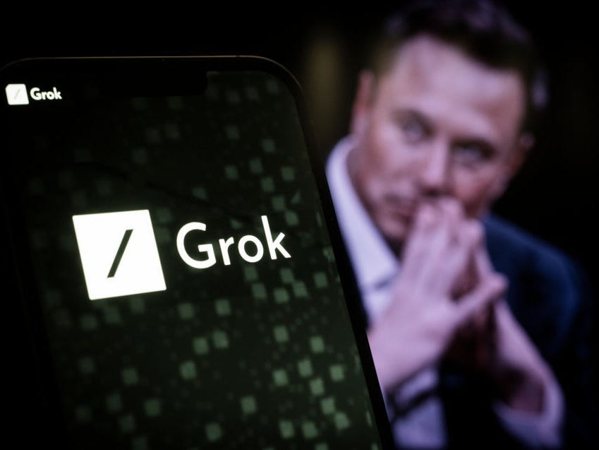 The xAI and Grok logos are seen in this illustration photo taken on November 5, 2023 in Warsaw, Poland. Elon Musk's xAI company this week introduced Grok, its conversational AI, which it says can match GPT-3.5 in performance.