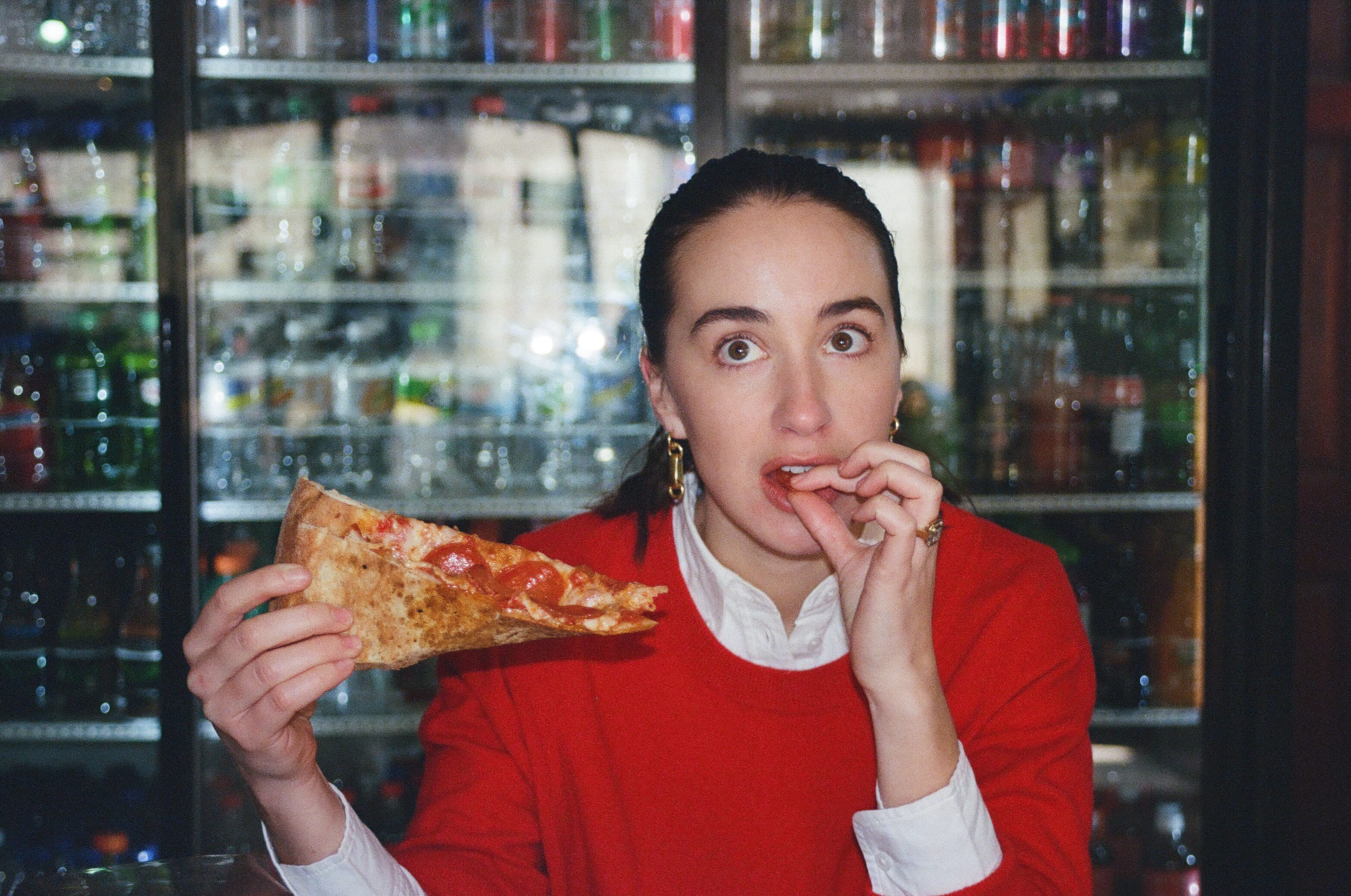 Feed Me newsletter writer Emily Sundberg, eating pizza