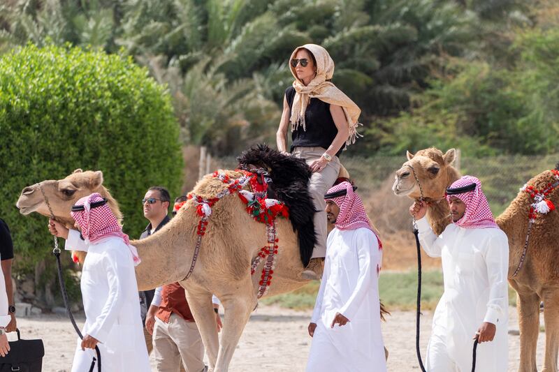 Noem rides a camel after a tour of Qal'at al-Bahrain Fort near Manama, Bahrain in May.