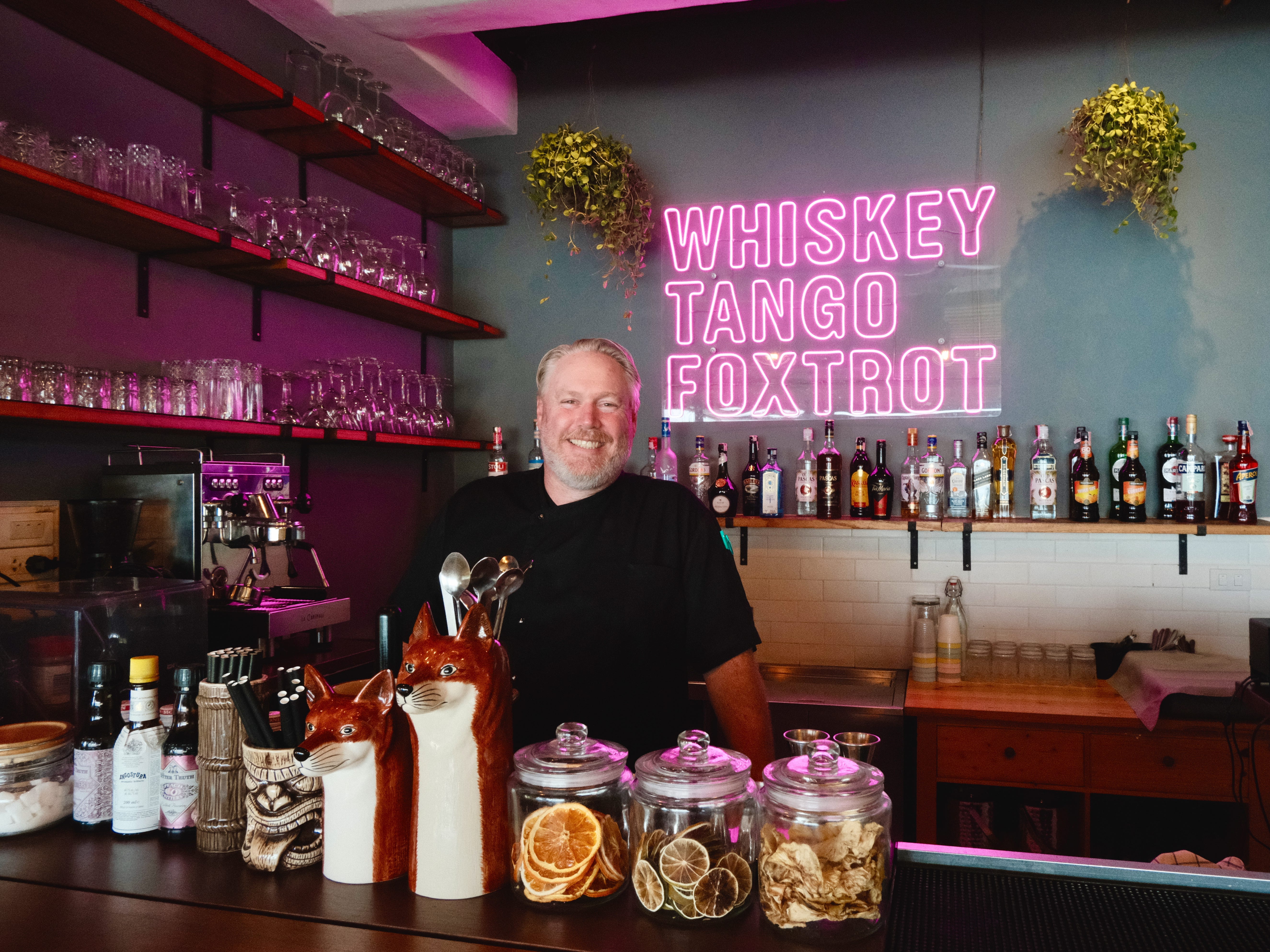 A man posing by the bar counter in a restaurant in Koh Samui, Thailand.