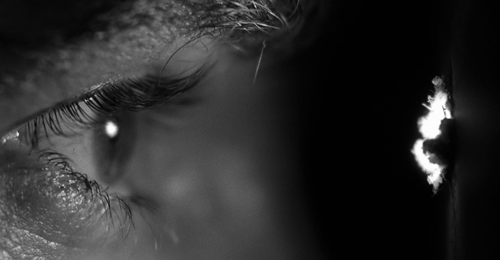 close-up of an eye looking through a peephole in Psycho