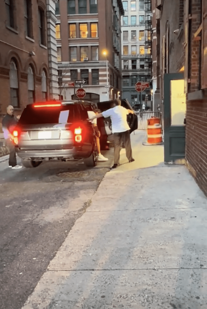 Travis Kelce getting out of a car on Friday night.