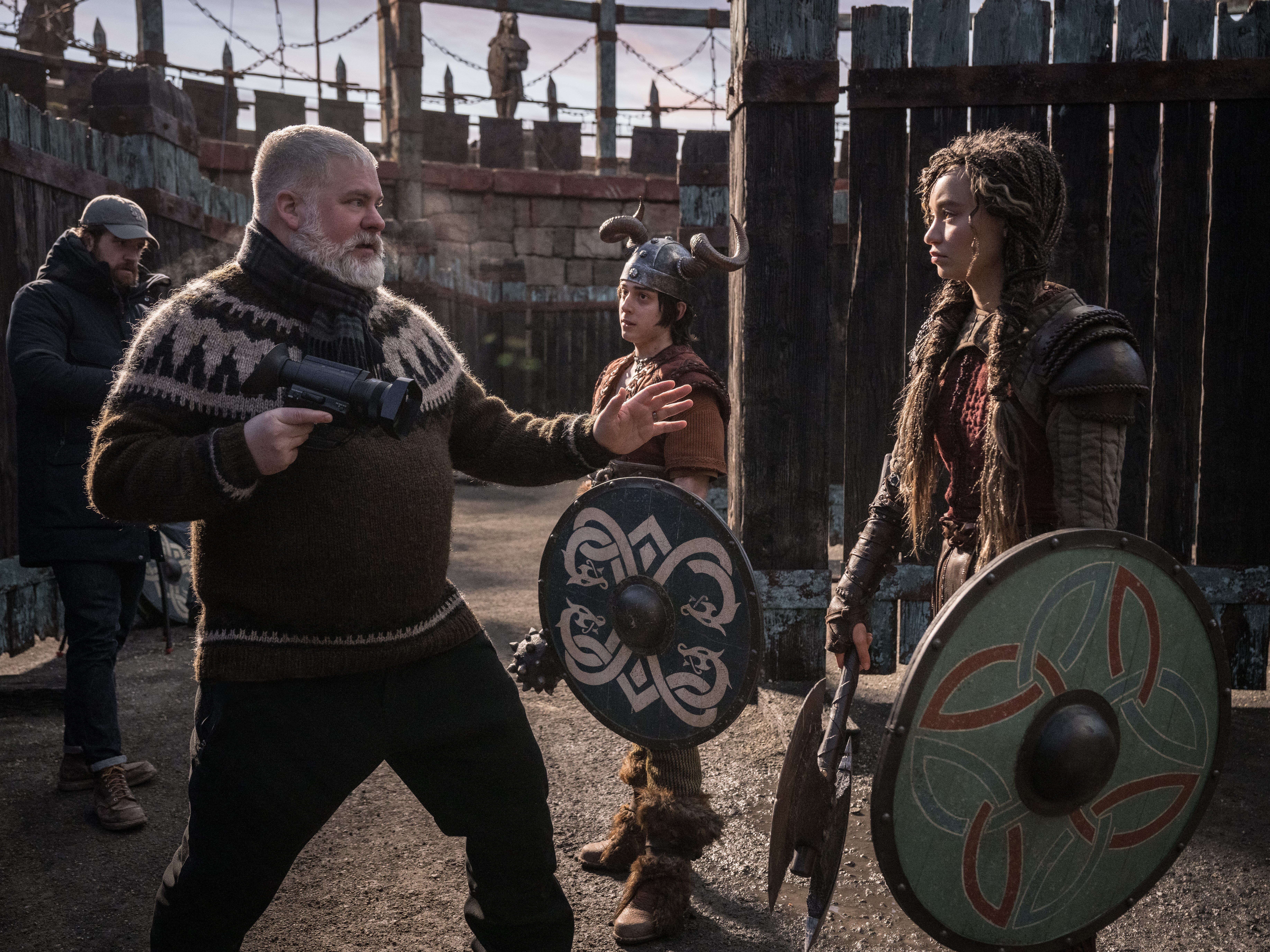 A still on the "How to Train Your Dragon" set showing Dean DeBlois directing Gabriel Howell and Nico Parker