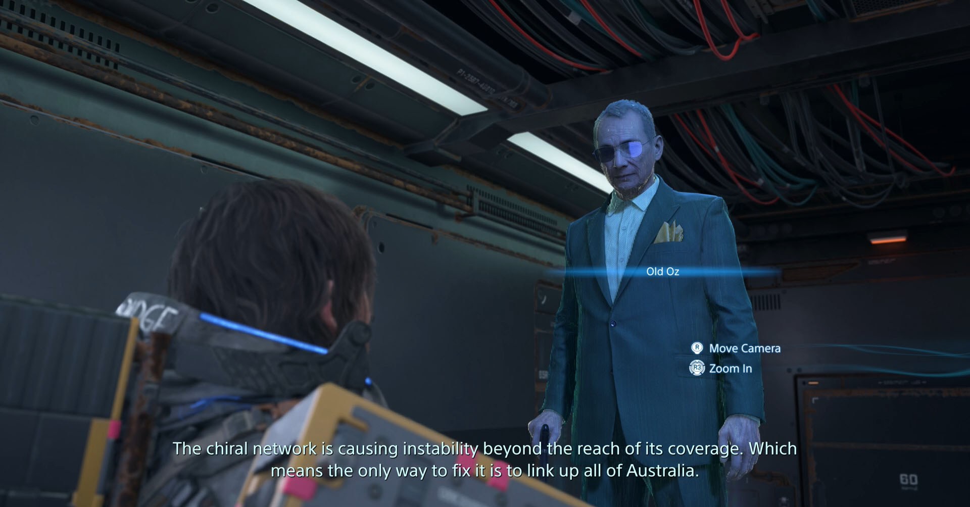 A Death Stranding 2 screenshot showing Sam talking to the hologram of an old man called Old Oz.