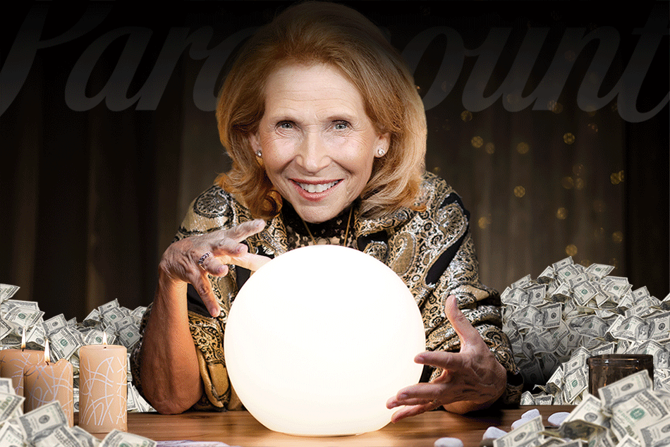 A woman gazes into a crystal ball surrounded by stacks of money.