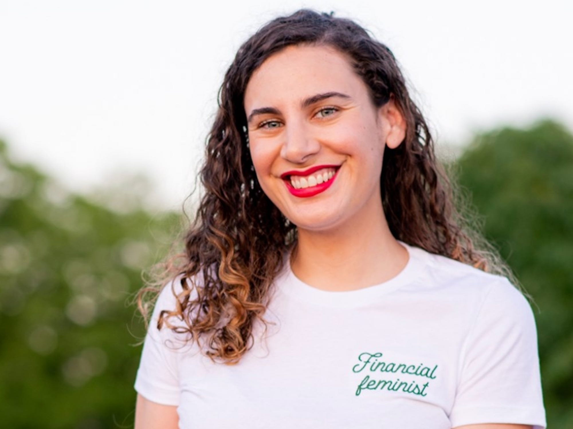 A headshot of a woman in a white T-shirt.