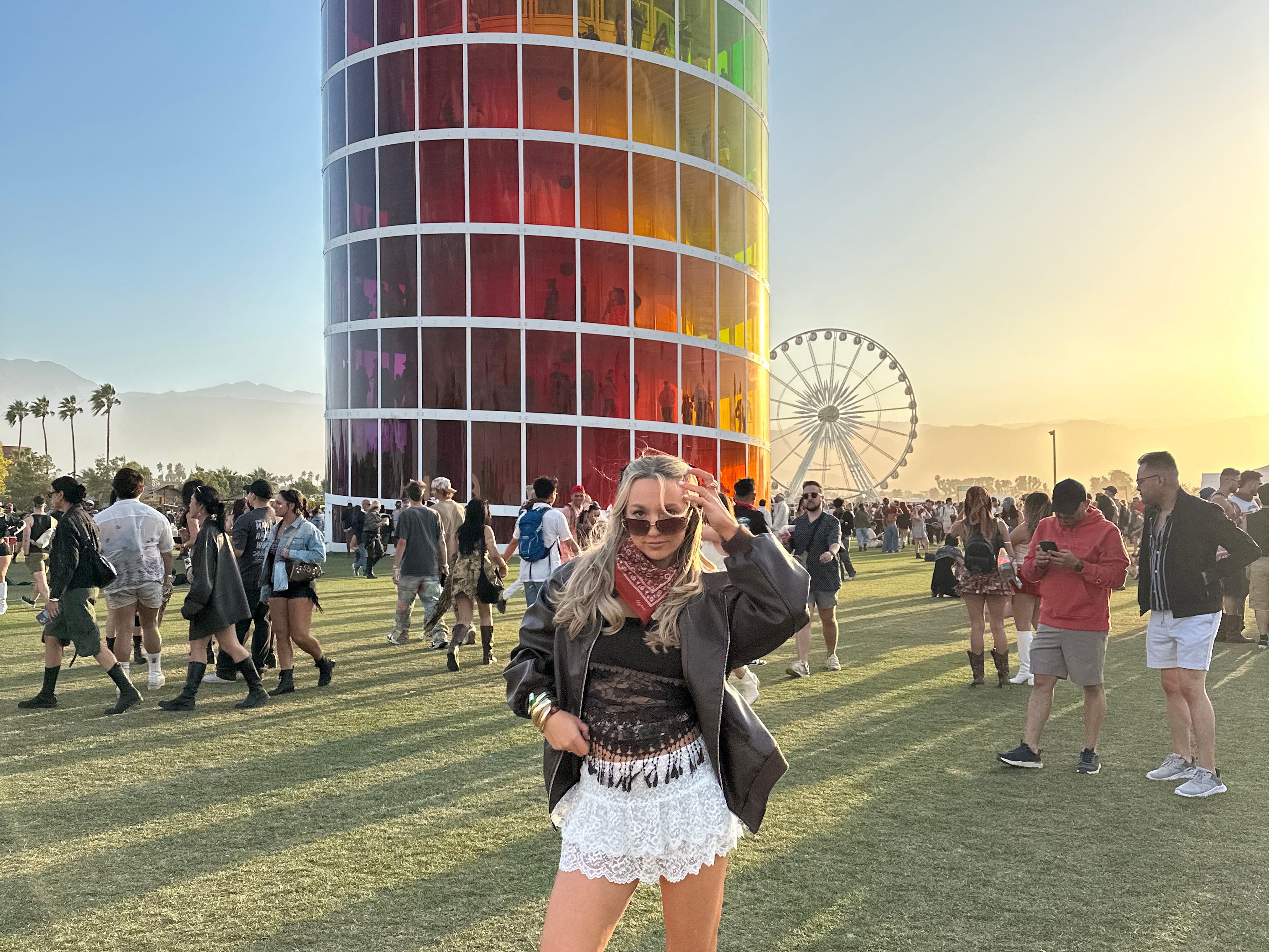 Chloe stands in front of a rainbow tower at Coachella Valley Music and Arts Festival.
