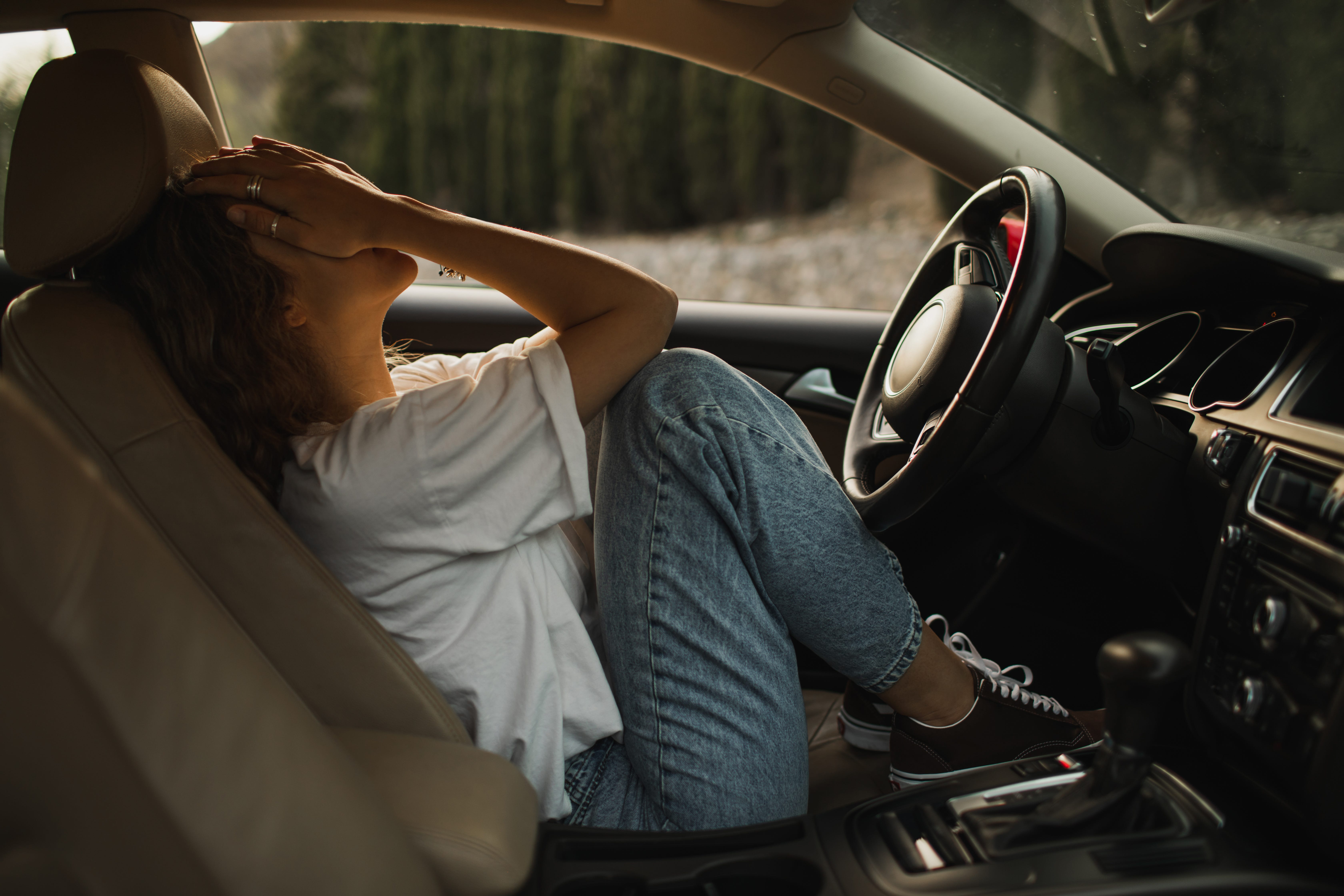 Upset woman crying in car.