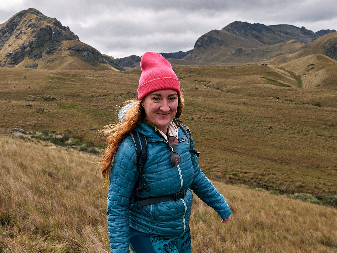 A woman standing in the mountains in South America.