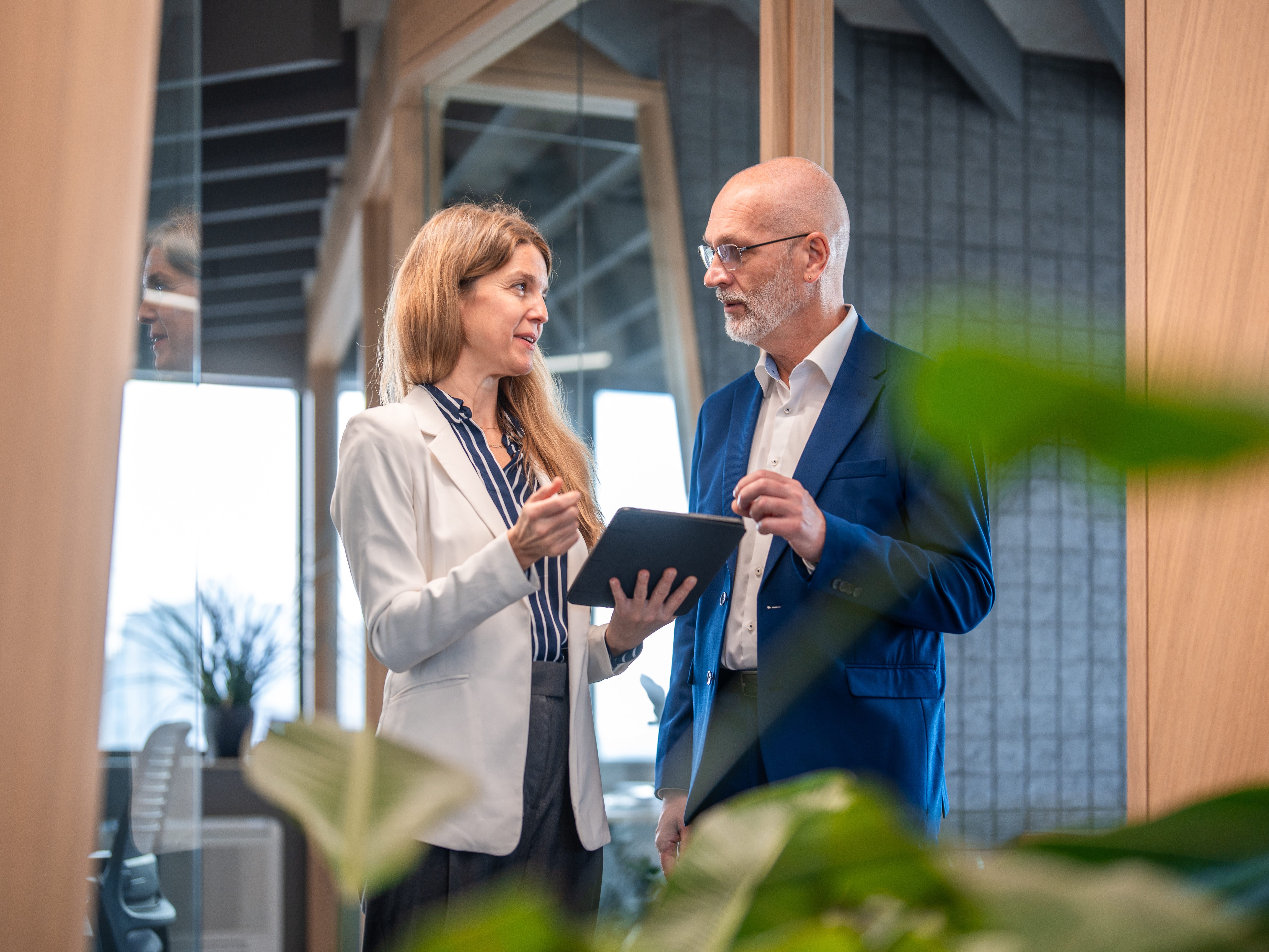 a younger woman and older man at work