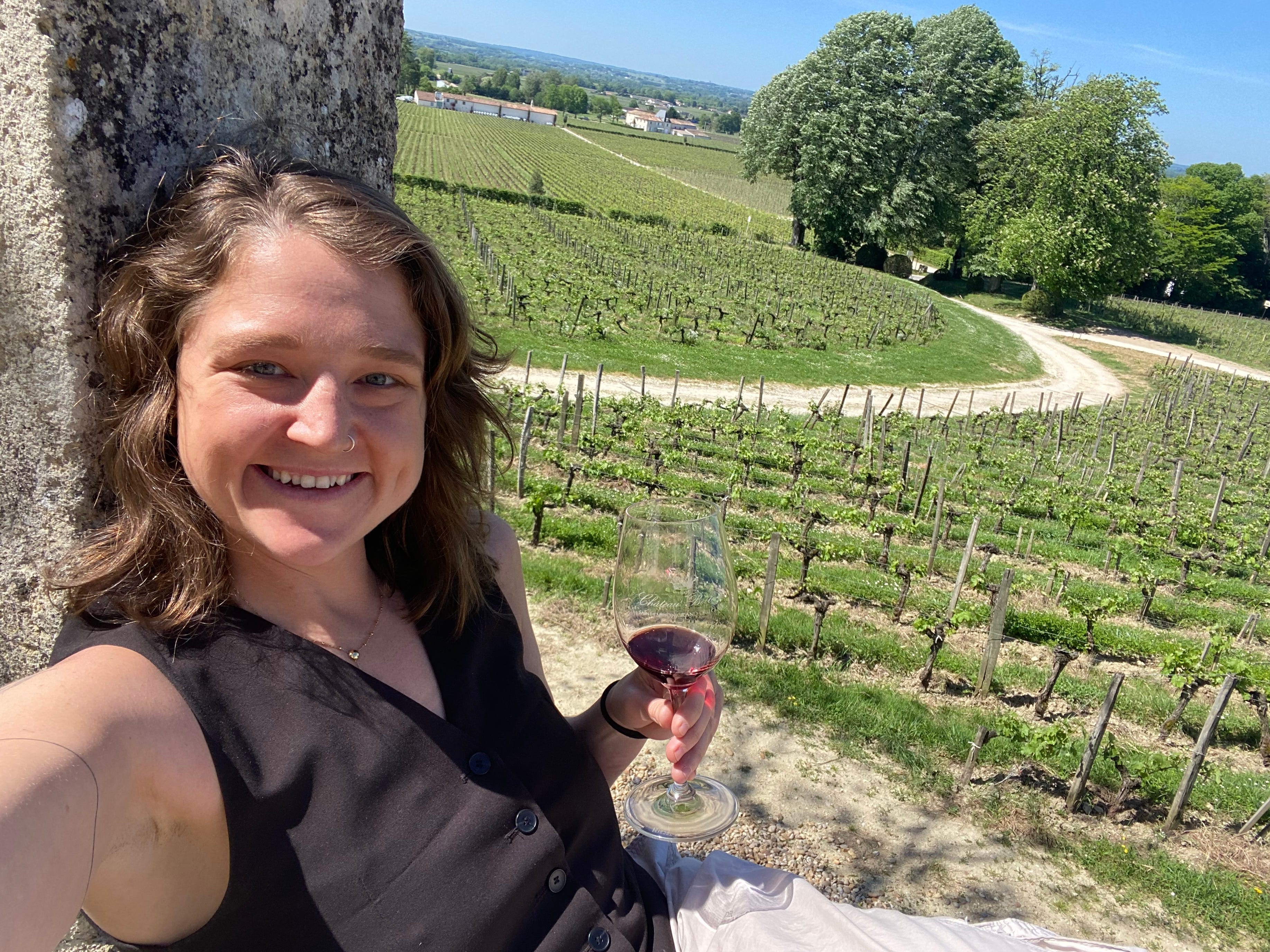 Jamie Bradley drinking wine on a vineyard in France