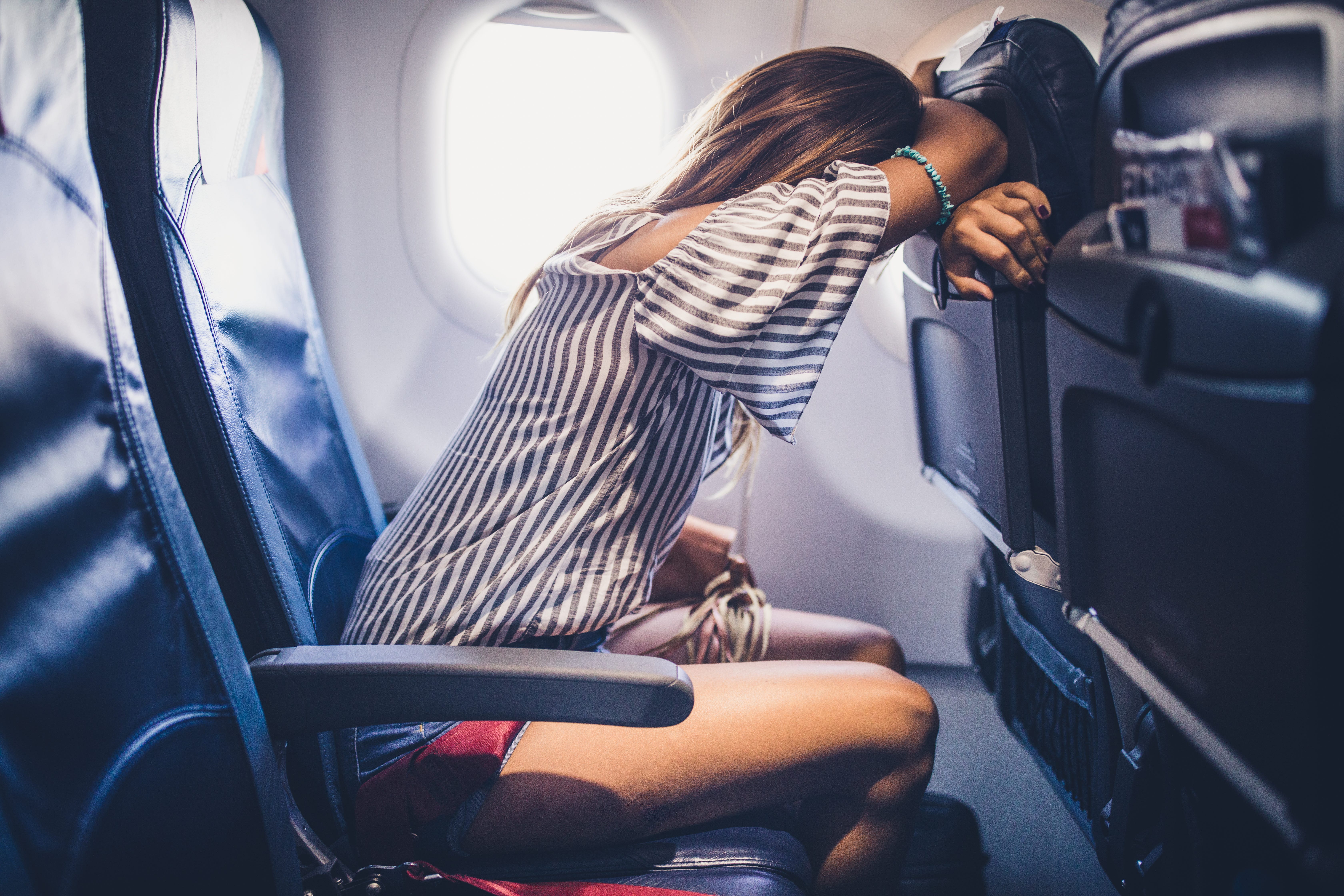 Woman taking a nap during the flight in a plane