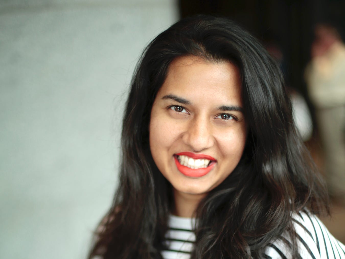headshot of a woman in a black and white striped shirt