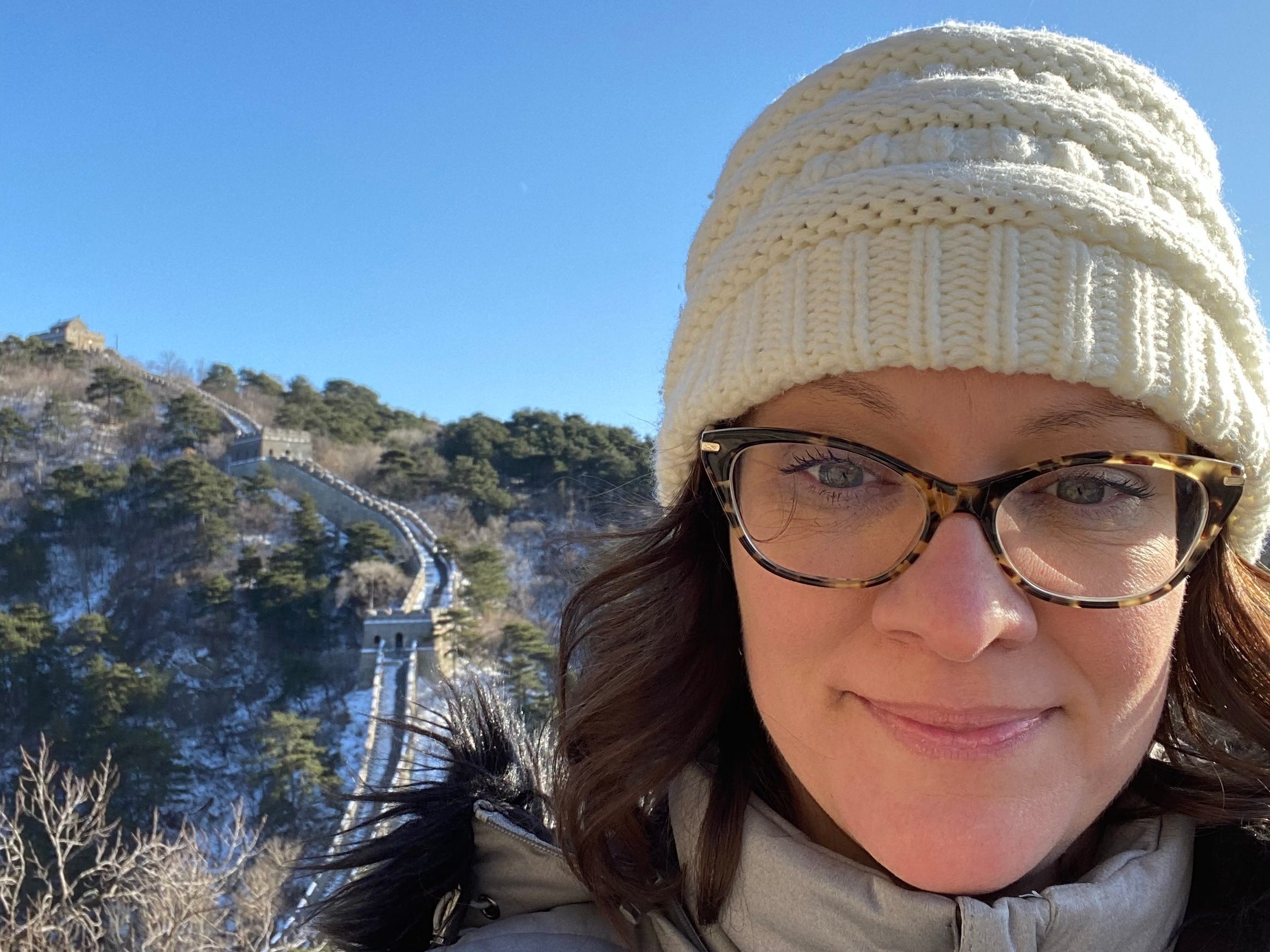 a woman takes a selfie at the Great Wall of China
