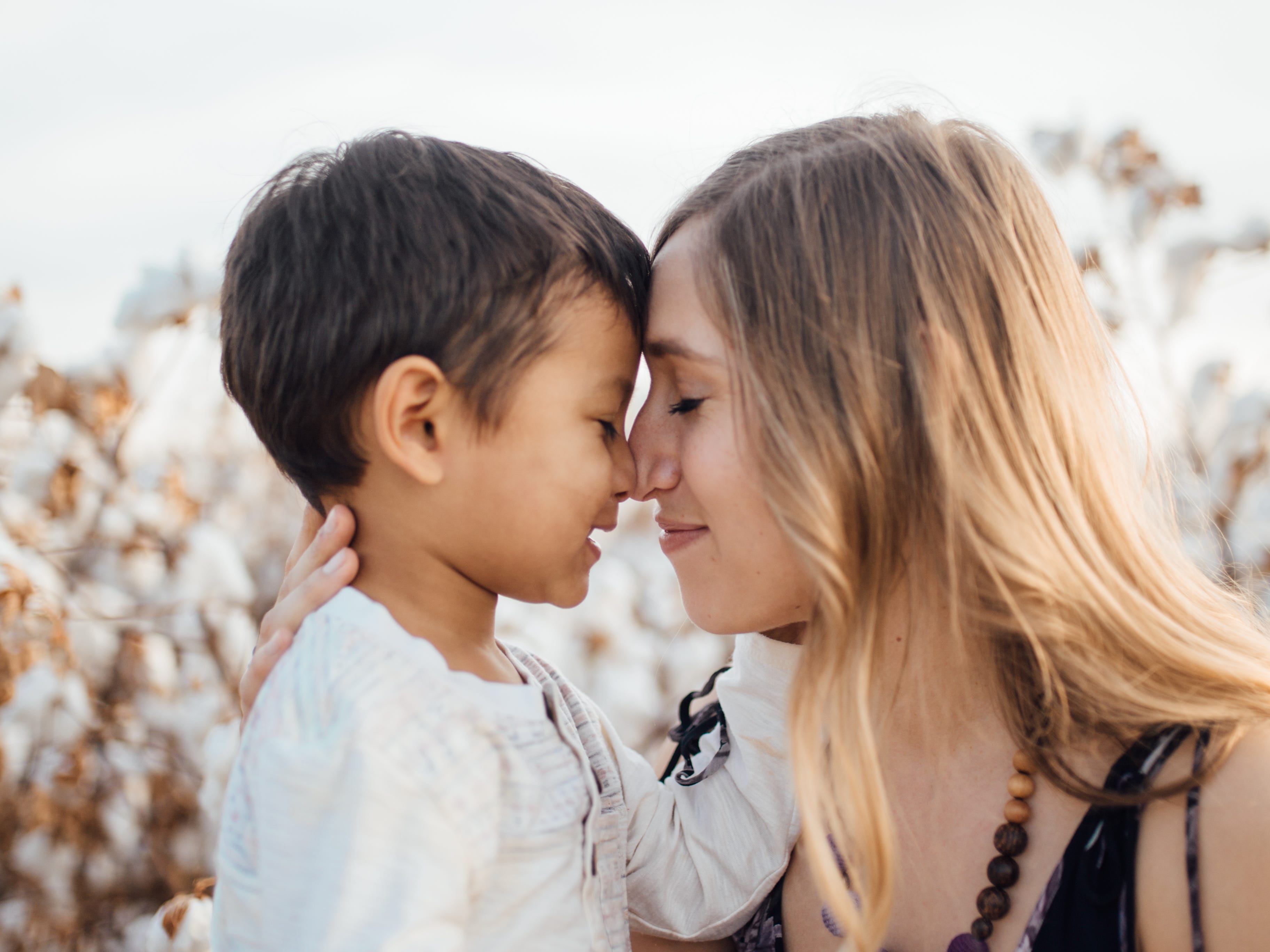 The author touching foreheads with her firstborn son.