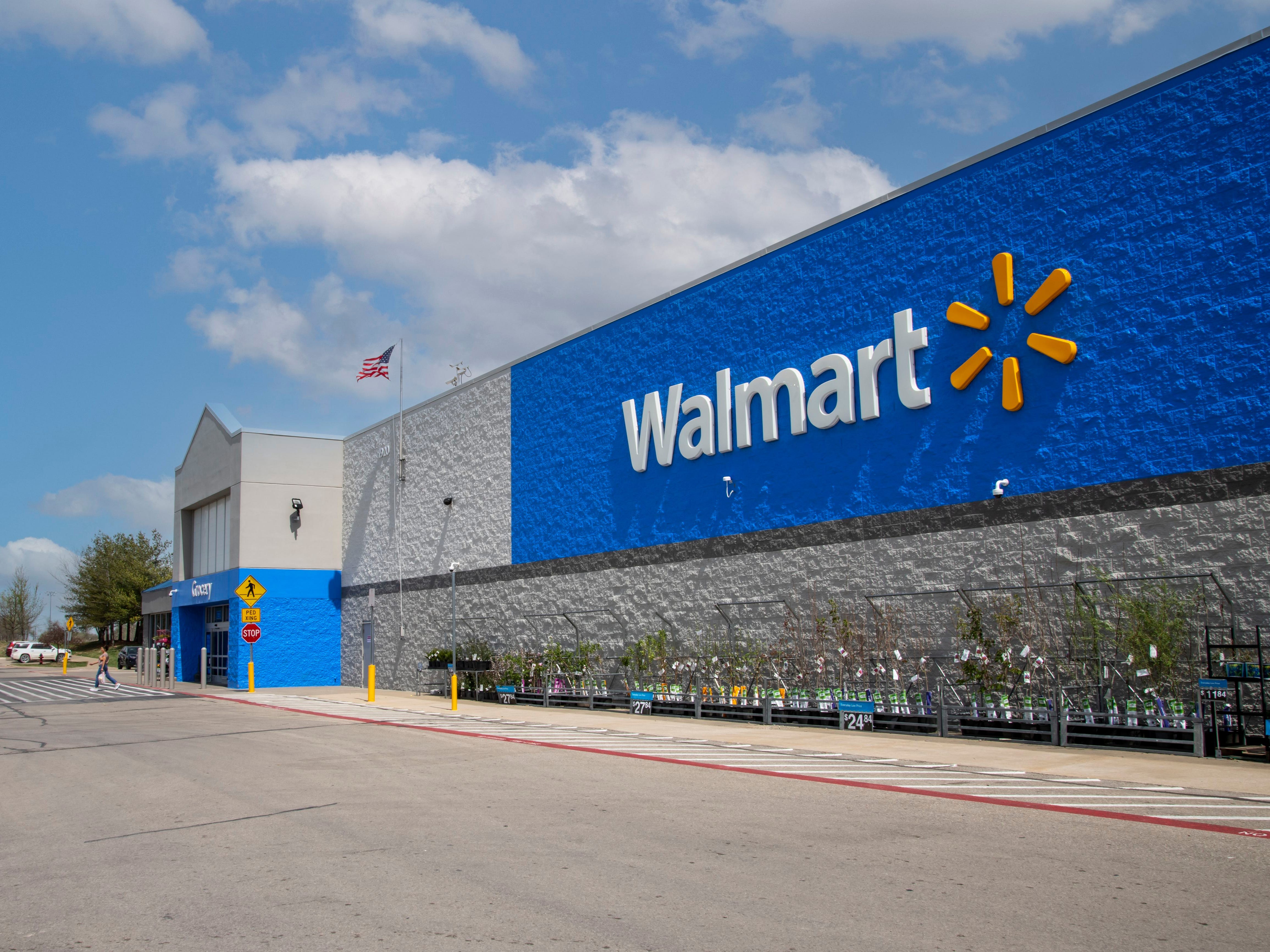 A Walmart store with the Walmart logo and gardening products on display.