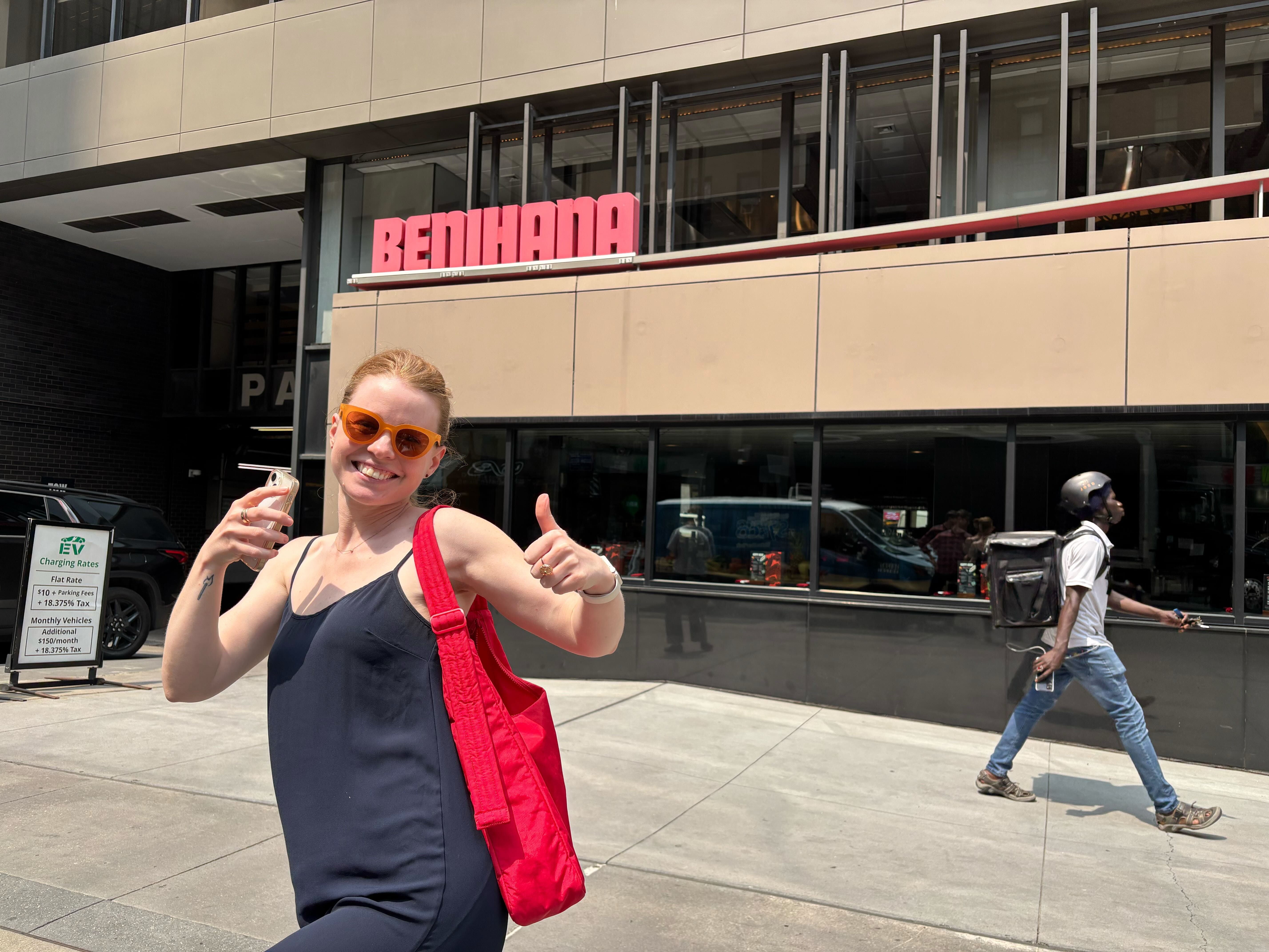 the author standing outside benihana giving a thumbs up