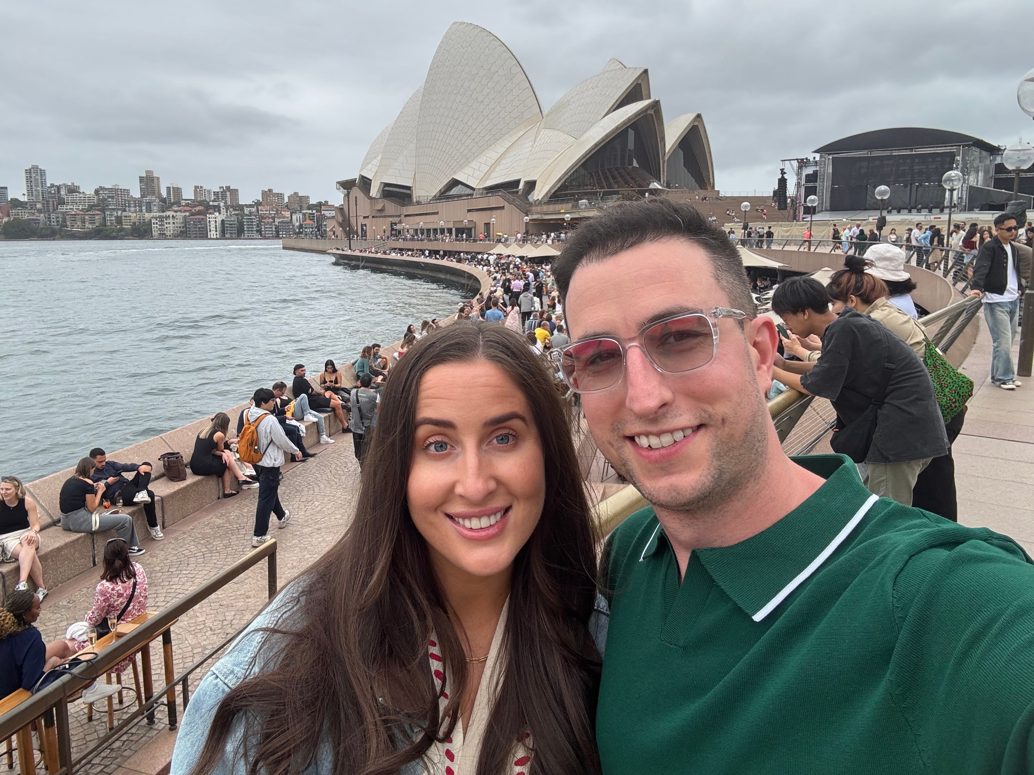 Jamie and her husband take a selfie in front of the Sydney Opera House.