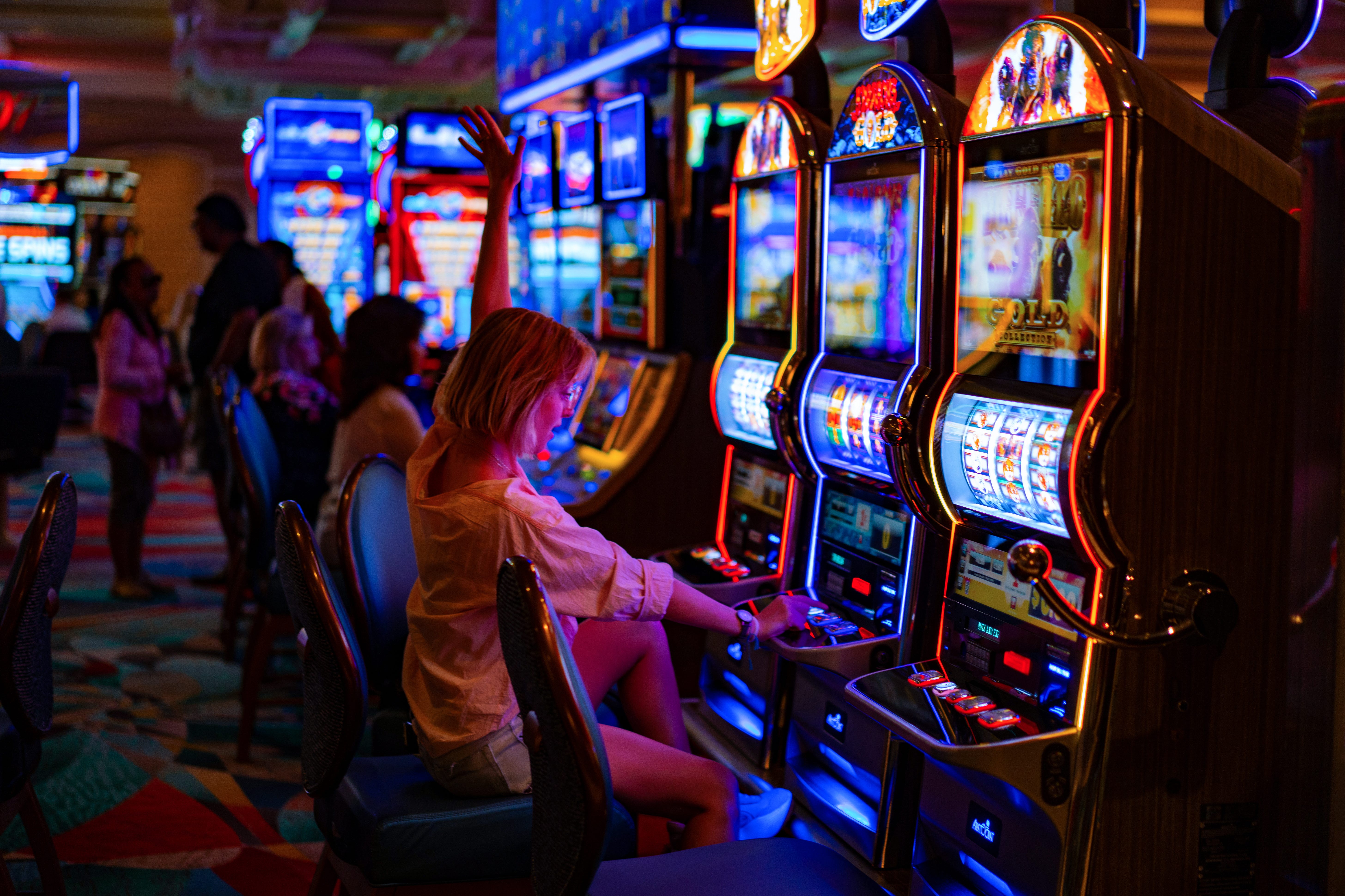 Woman smiling while playing slot machine