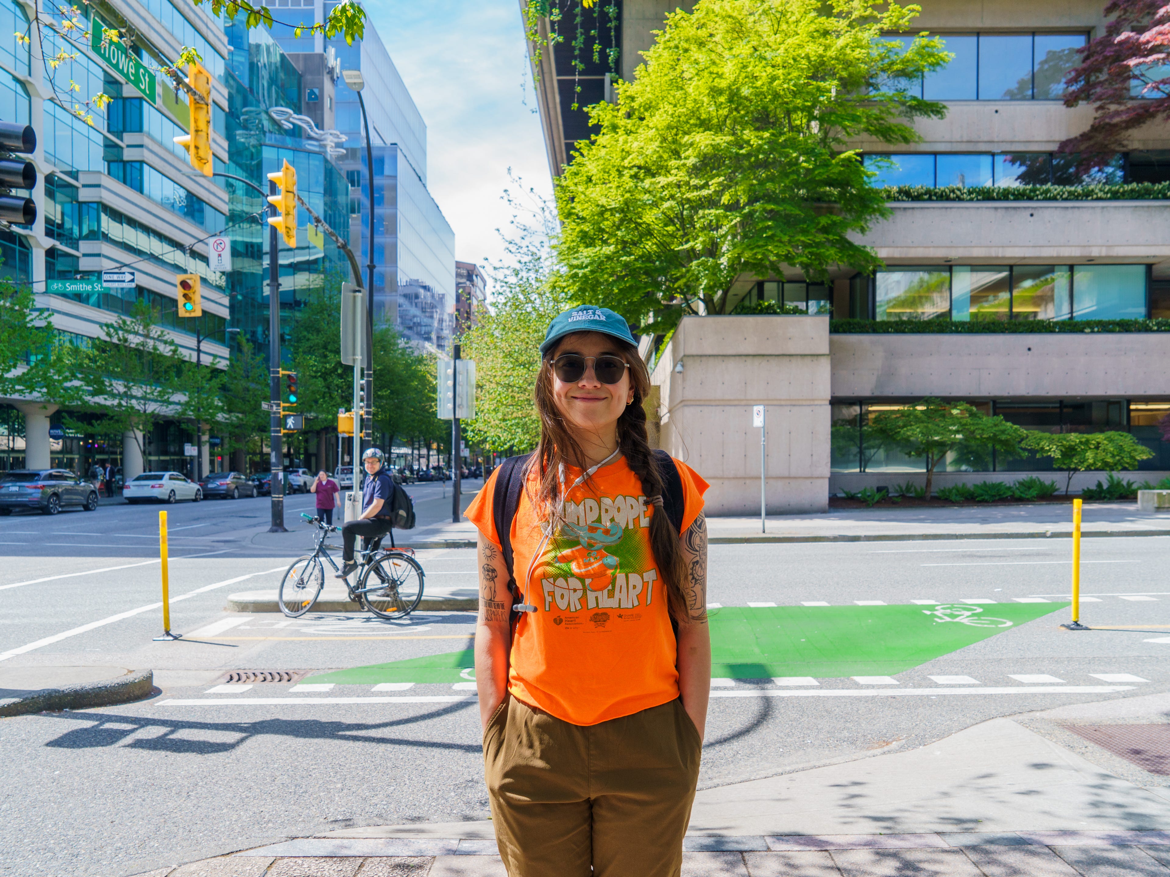 The author stands smiling in front of a city street in Vancouver