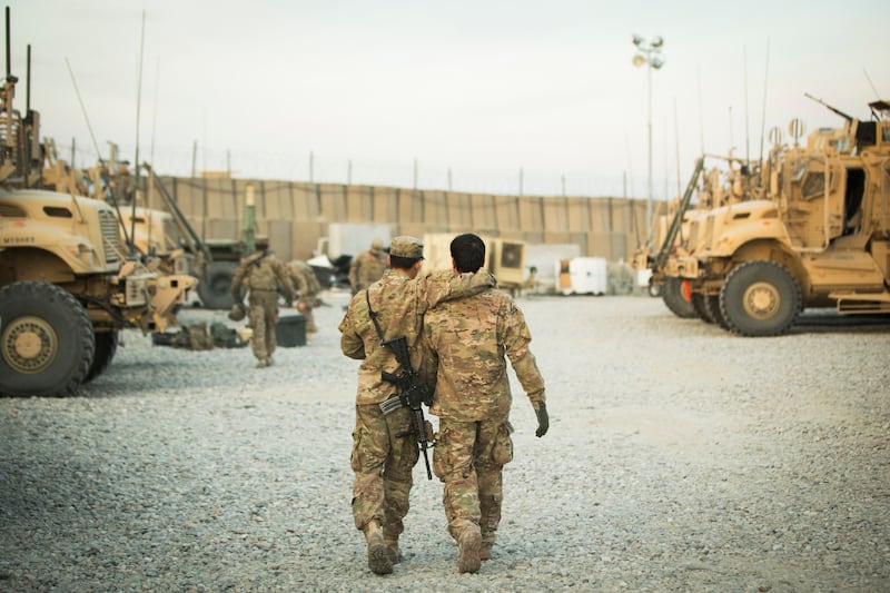 A U.S. soldier from the 3rd Cavalry Regiment walks with the unit's Afghan interpreter before a mission in 2014. Local interpreters played a pivotal role in the U.S. military's operations in Afghanistan.
