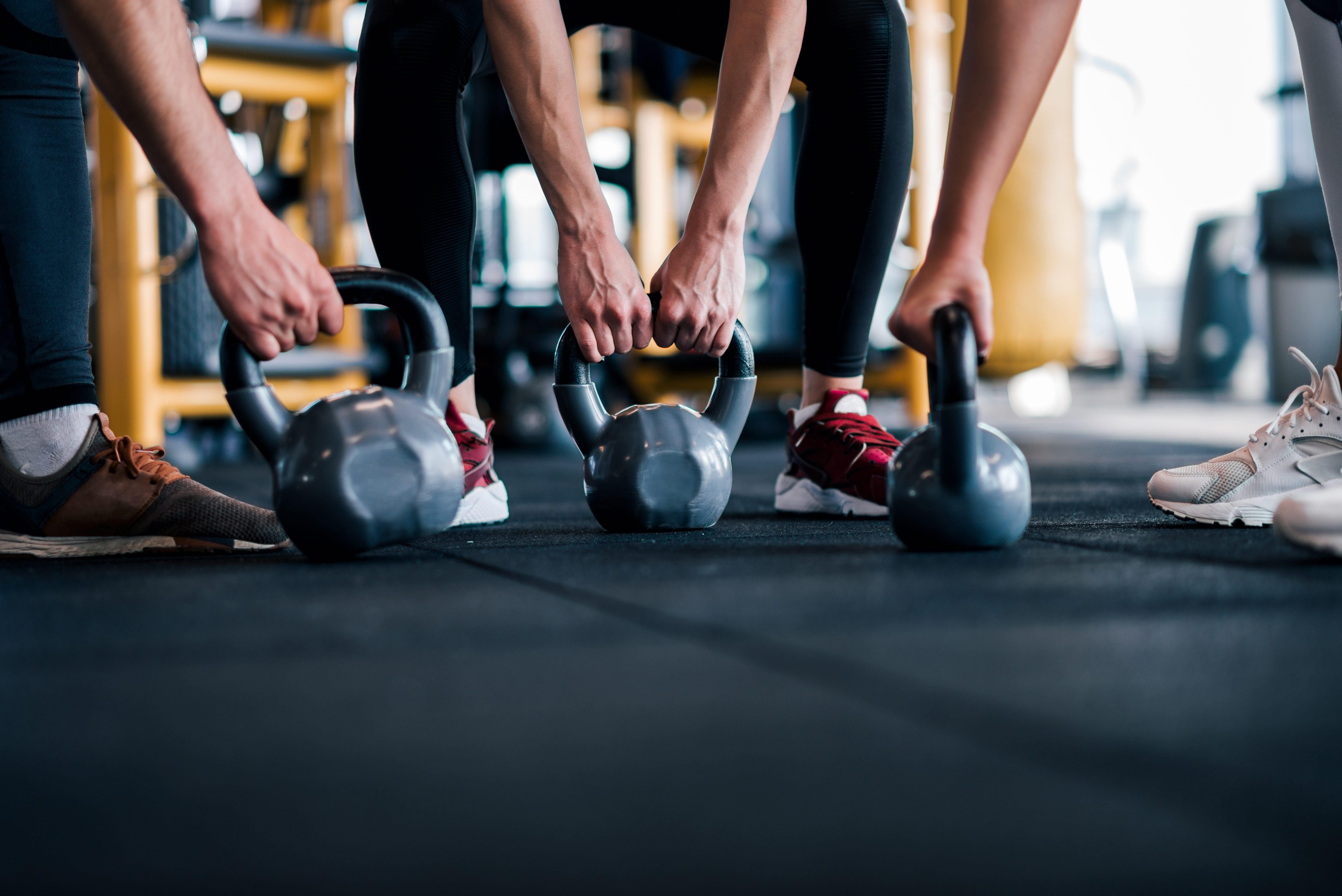 People picking up weights in a gym.