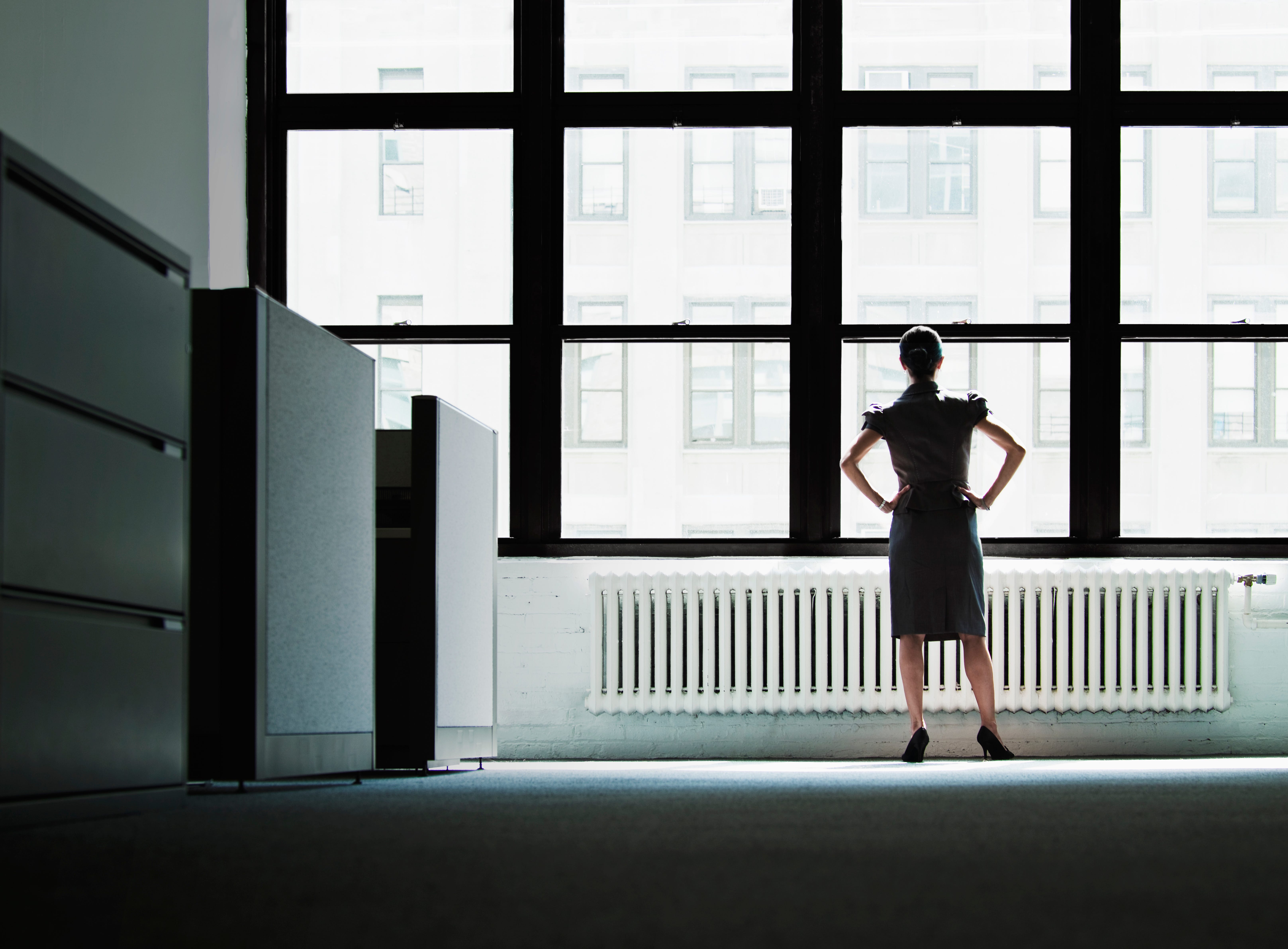 A business woman stared out an office window.
