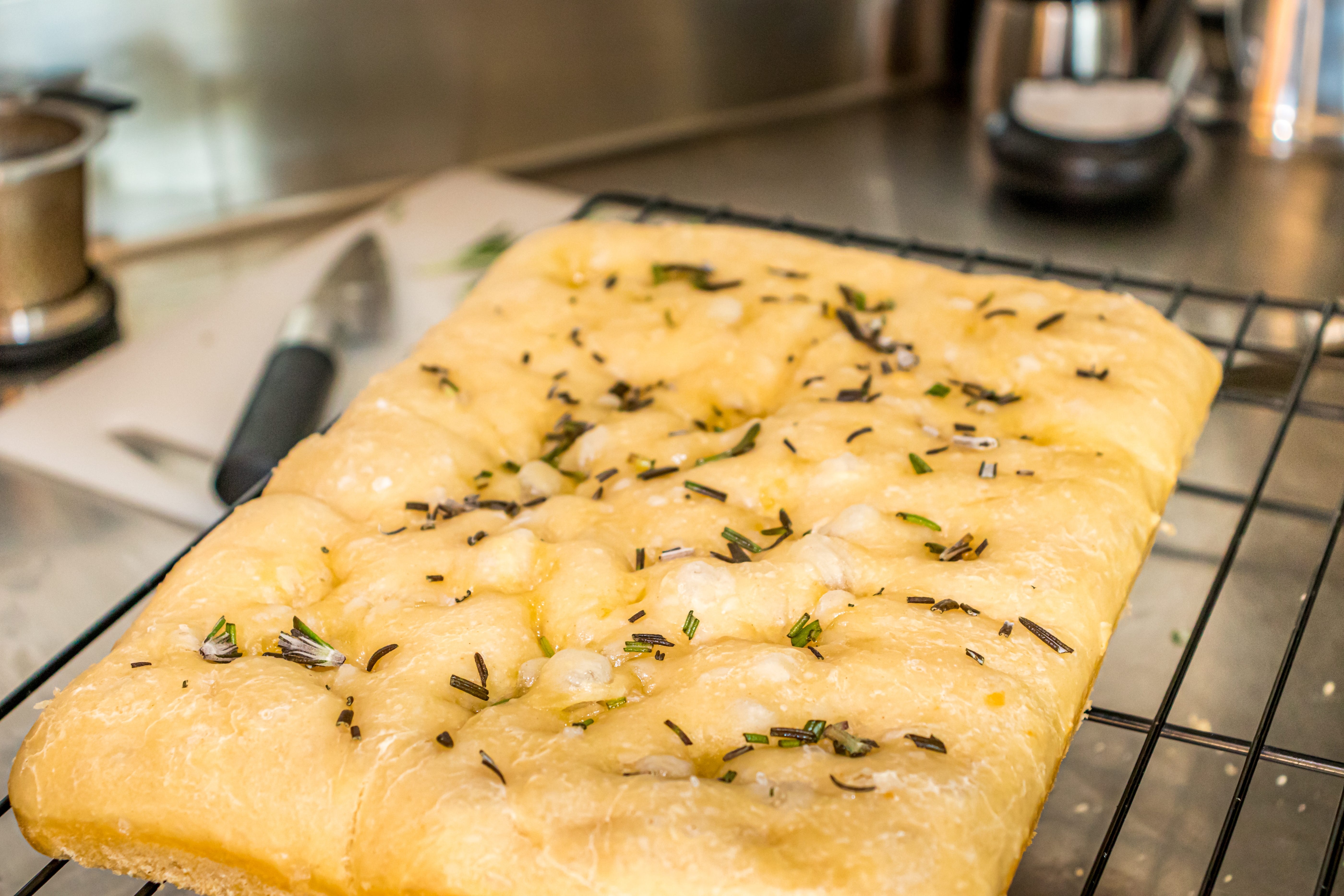 Homemade focaccia on someone's kitchen table.