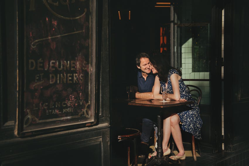 Author Kasia Dietz and her partner sitting at a table at a restaurant