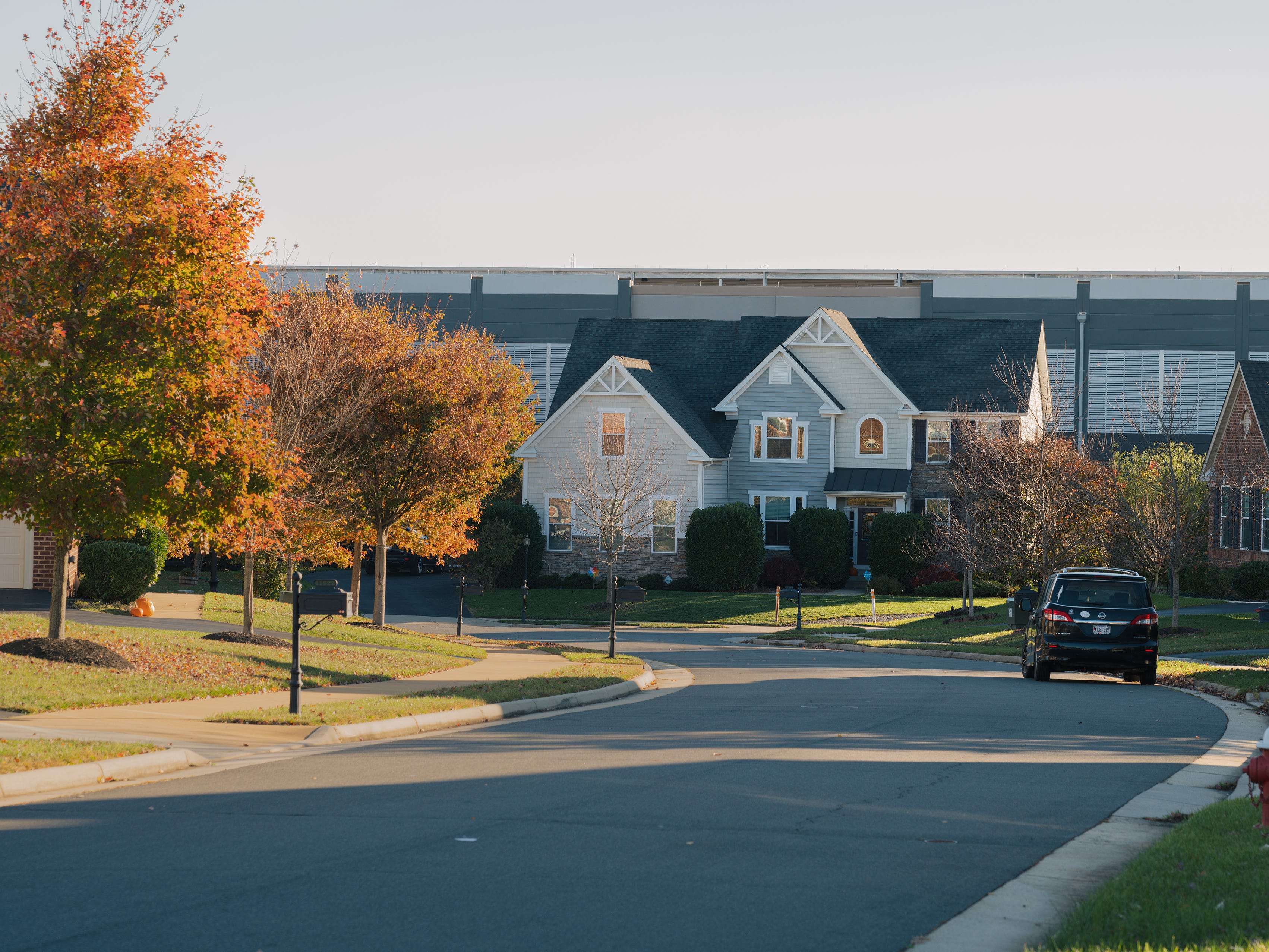 A neighborhood with a data center in the background