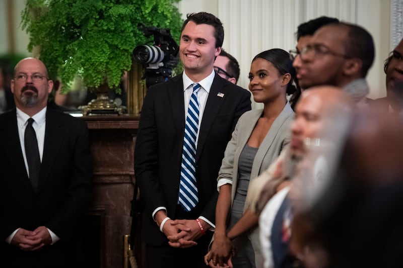 Candace Owens and Charlie Kirk listen as Donald Trump speaks during the 2018 Young Black Leadership Summit.