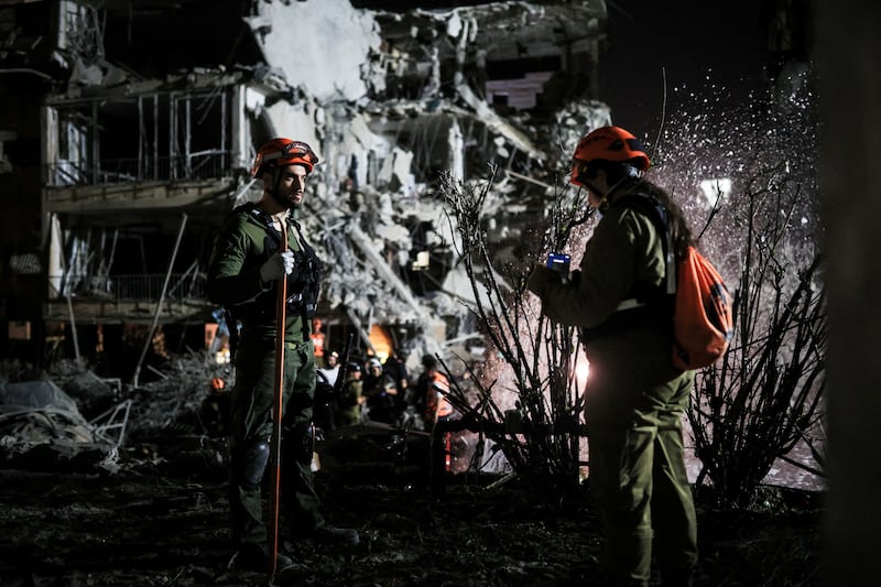 Rescue and security personnel work at an impact site following missile attack from Iran on Israel in Ramat Gan on June 13,  2025.