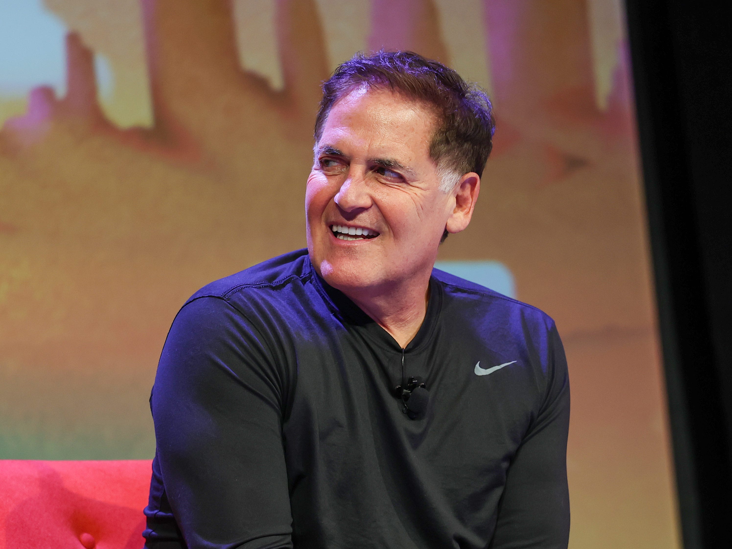 Mark Cuban sitting in a red sofa.