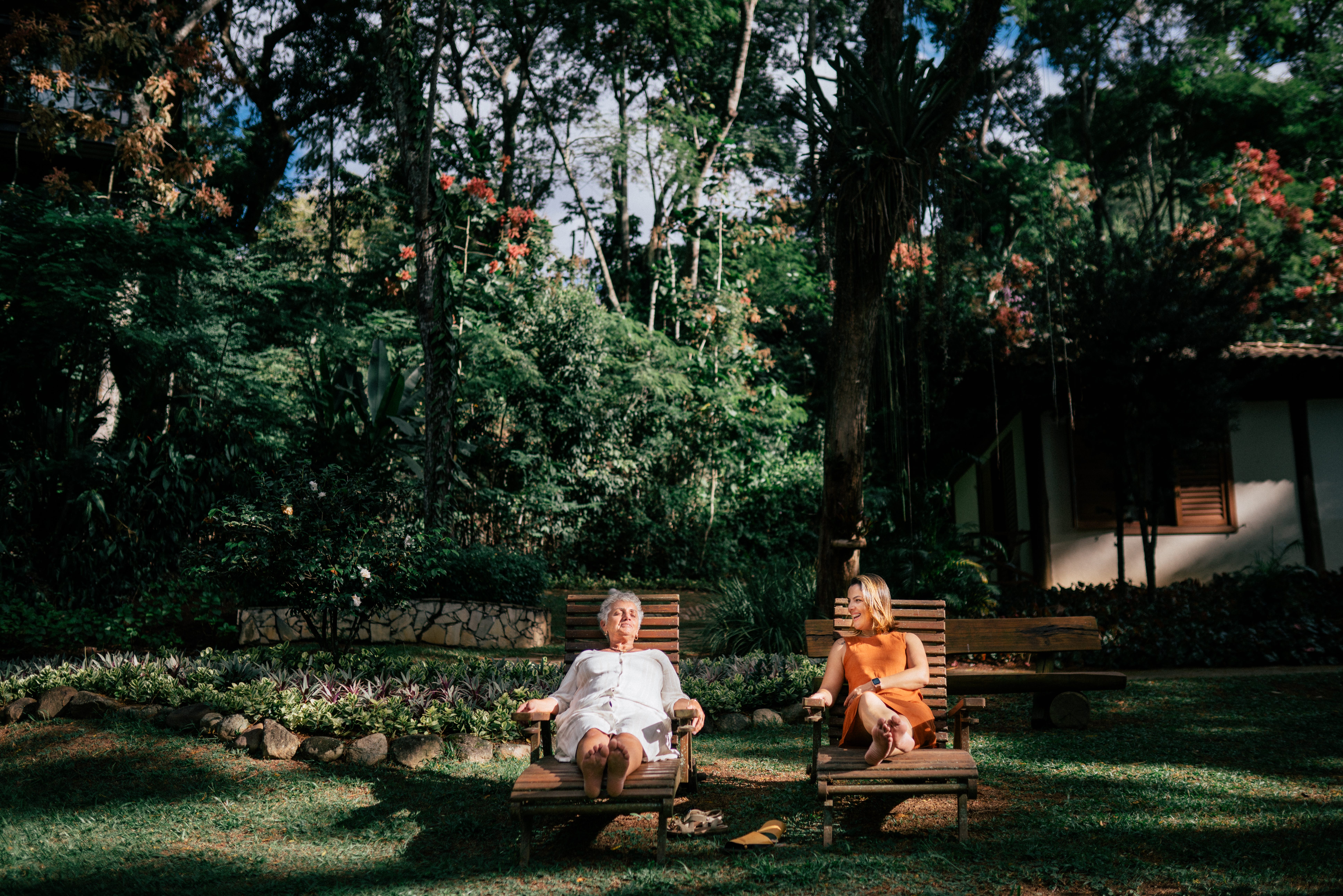A mom and daughter sit together in a patio.