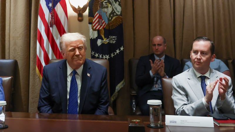 President Donald Trump reacts as Sergio Gor and White House Chief of Staff Susie Wiles sit next to him on the day of a meeting with U.S. ambassadors at the White House on March 25, 2025.