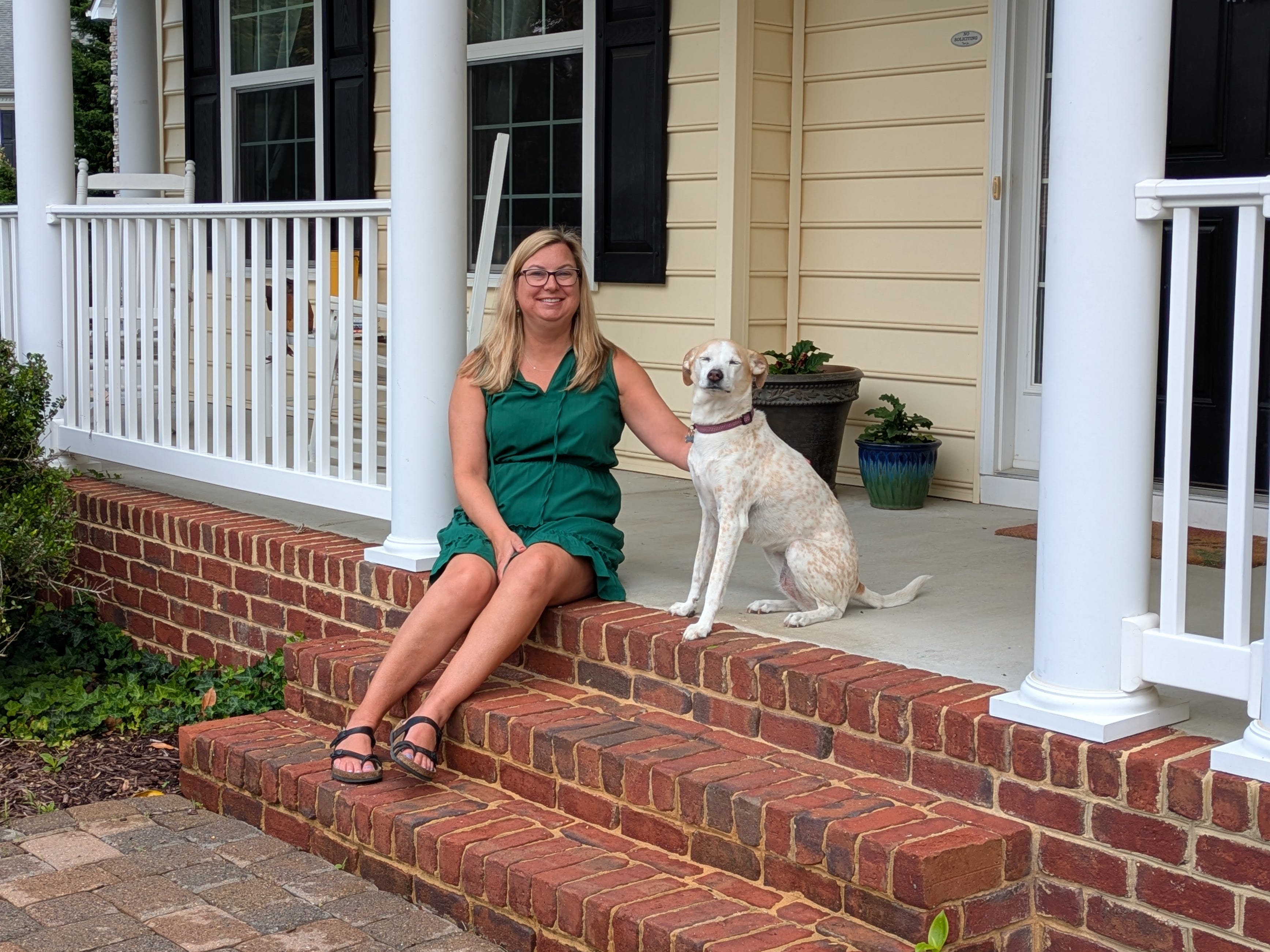 Lauren Evoy Davis in a green dress with her dog