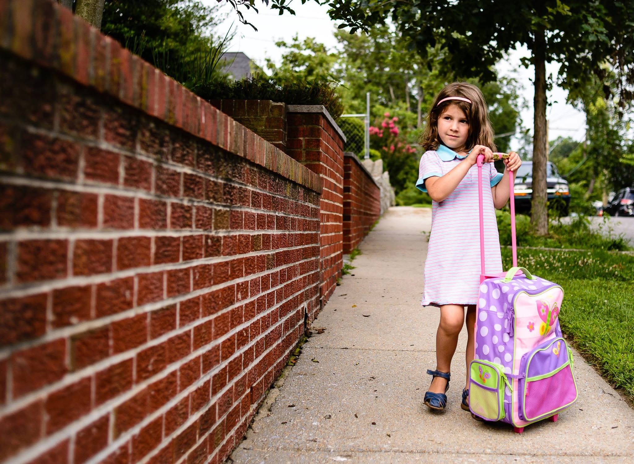Girl with roll on suitcase