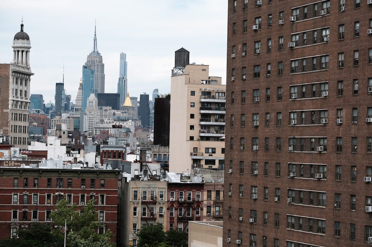 Residential apartment buildings with the Empire State Building in the background in New York City.