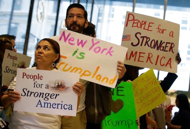 People with signs saying "New York is Trumpland."