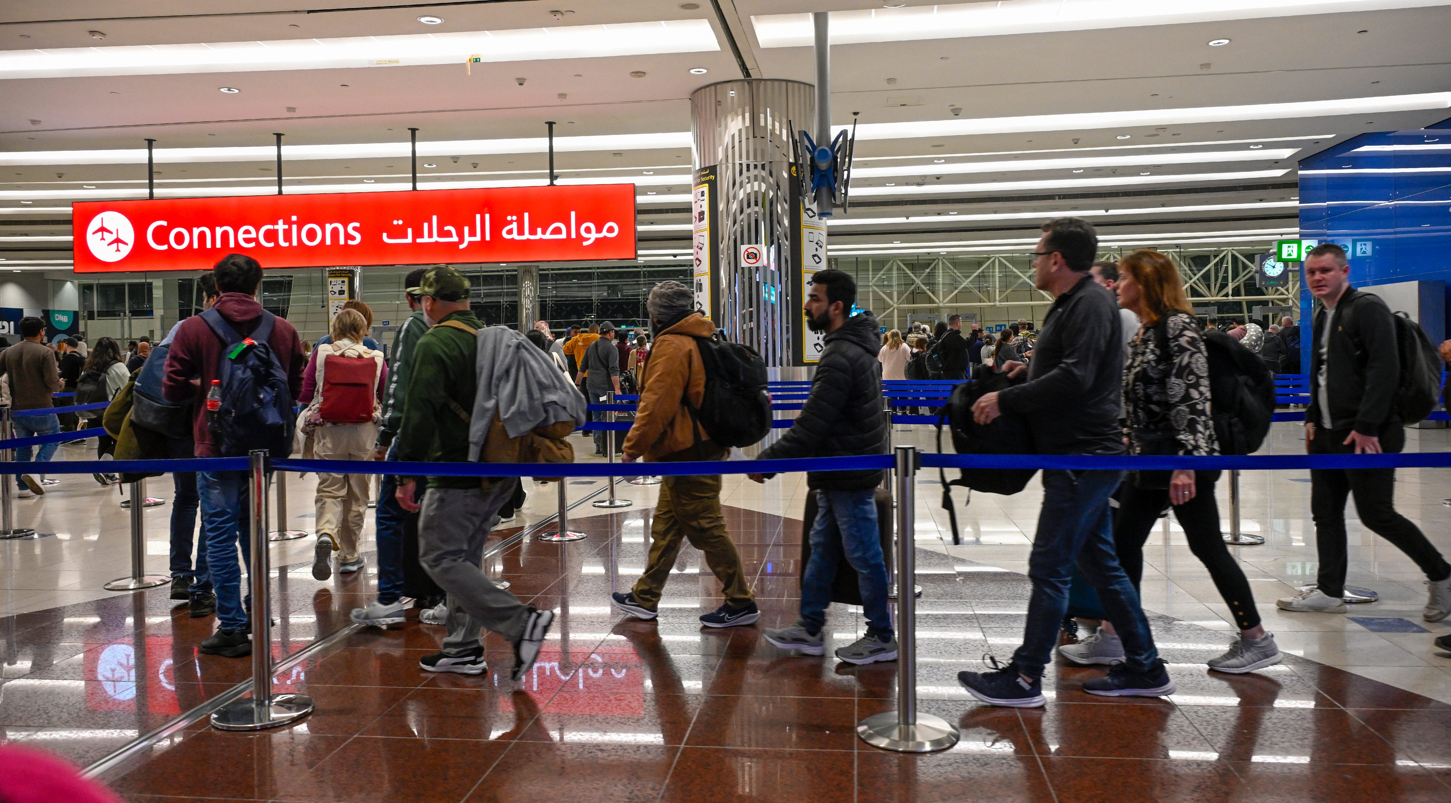 Arriving passengers walk towards connecting flights in Dubai International Airport on February 19, 2025, in Dubai, United Arab Emirates.