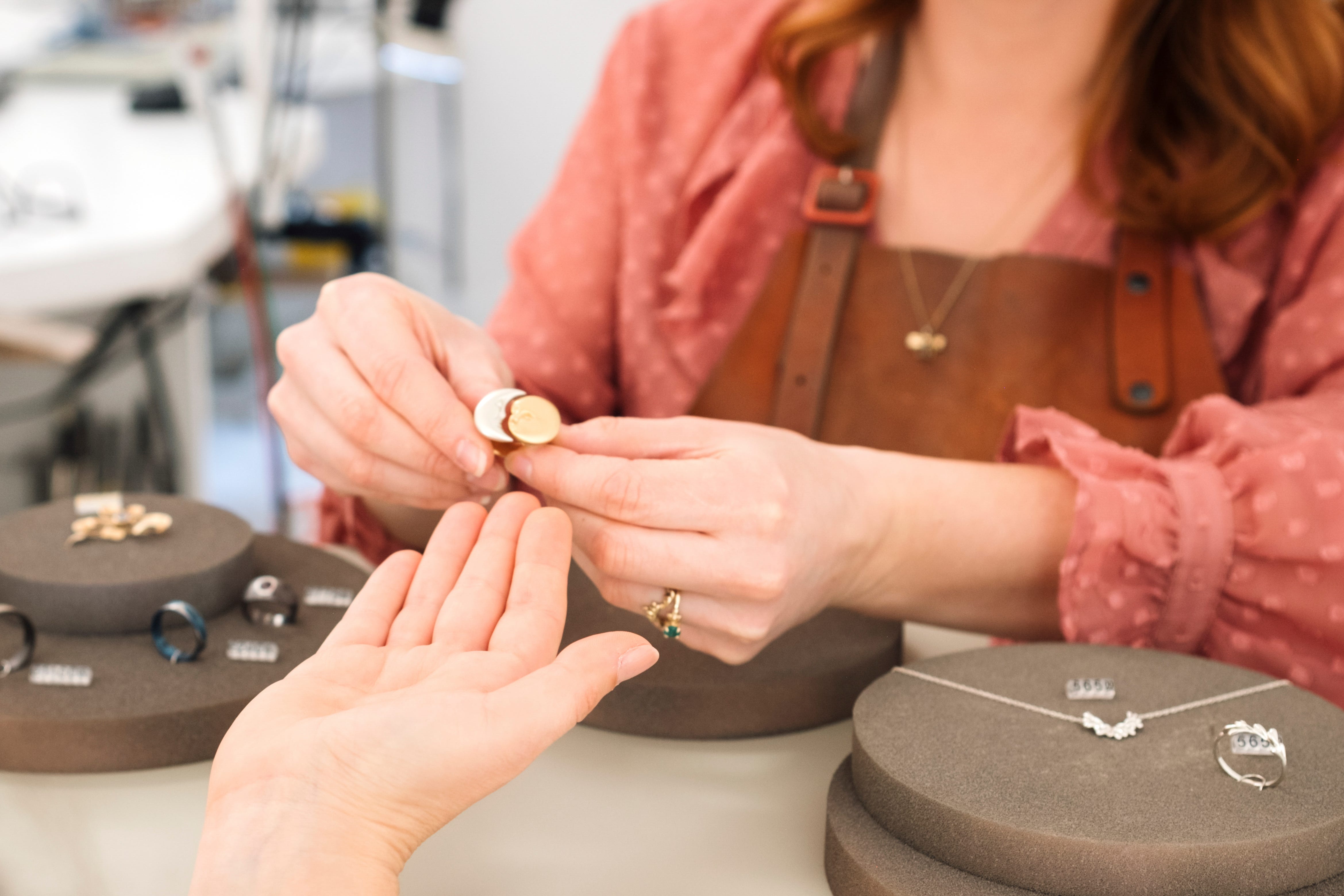 A woman choosing a ring in a jewelry store.