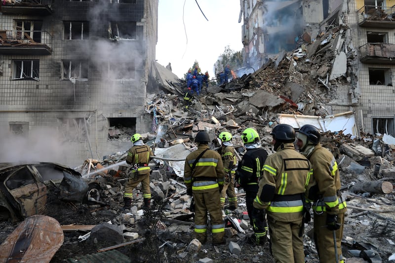 Rescuers conduct search and rescue operation at partially collapsed residential building after Russian drone-and-missile attack on June 17, 2025 in Kyiv, Ukraine