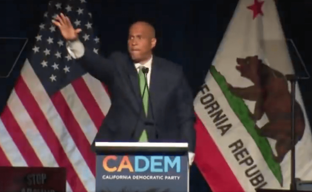 Booker makes the gesture, similar to the Nazi salute, during his speech.  