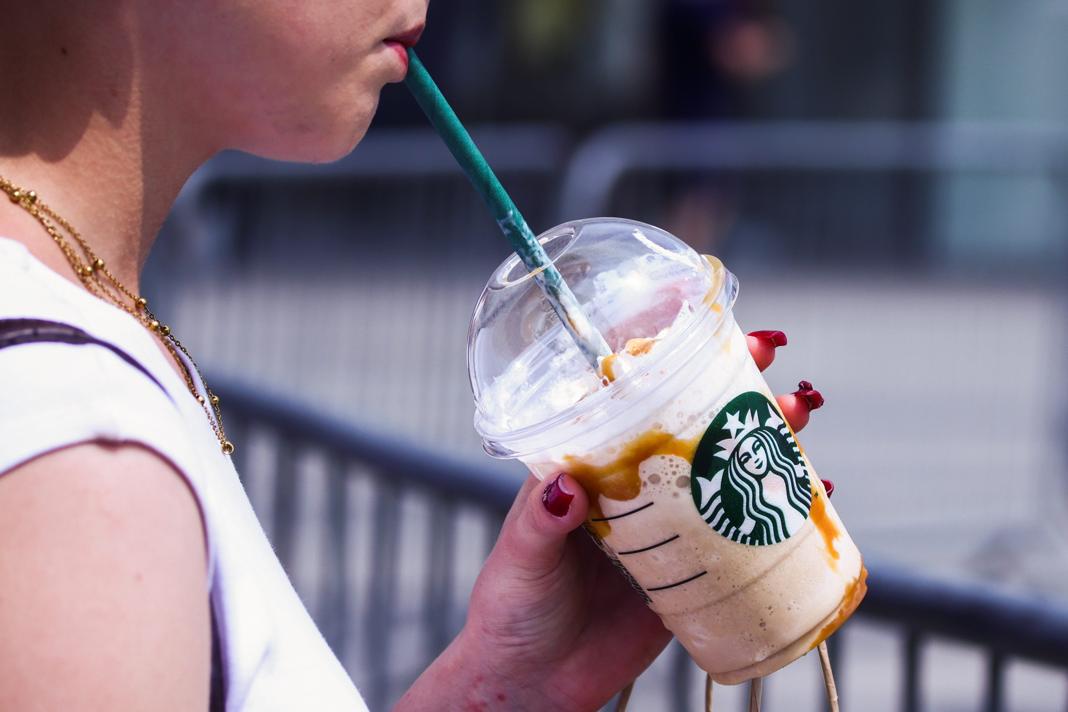 Woman drinking a Starbucks drink