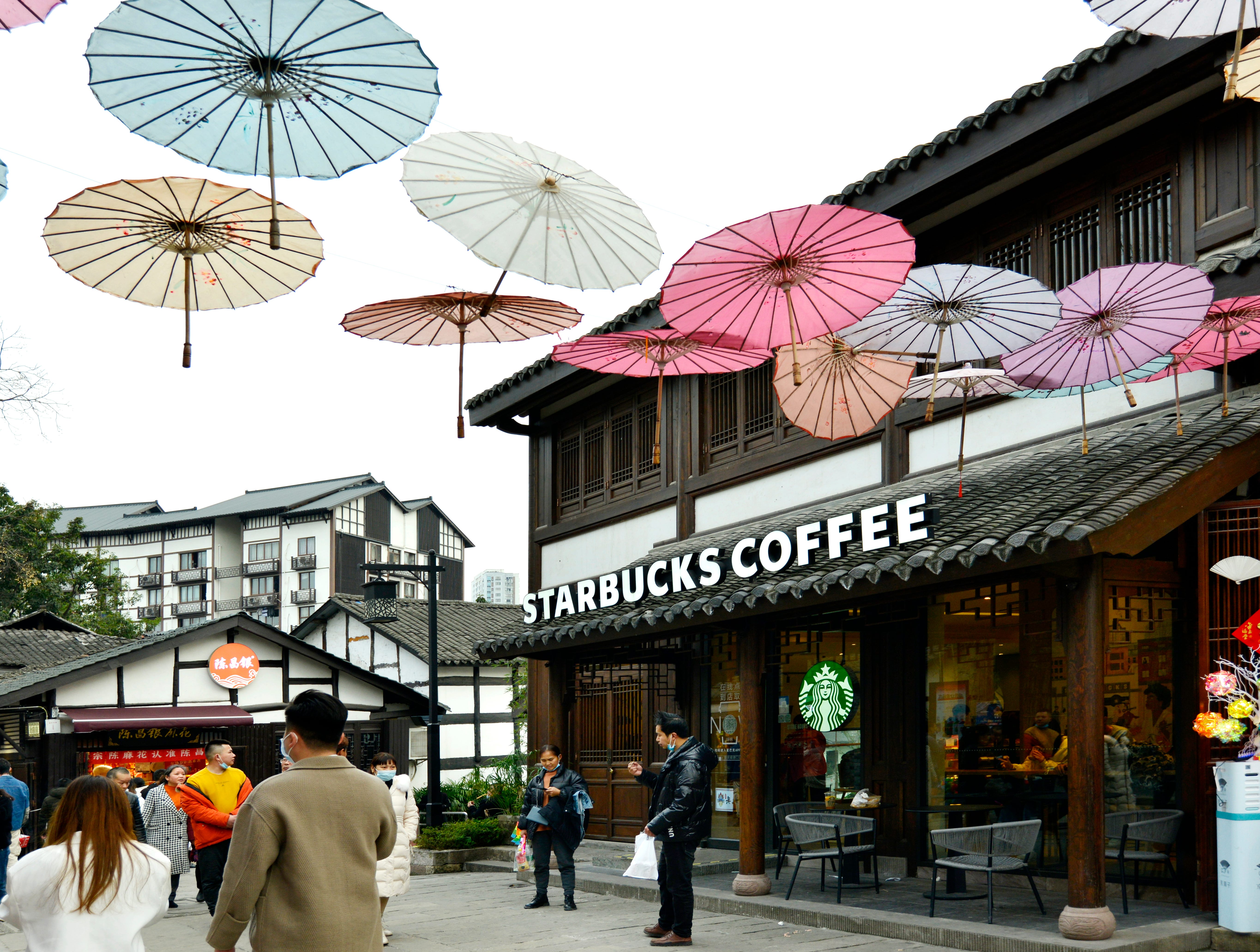 People walk by a Starbucks Coffee at Ciqikou ancient town on February 14, 2022 in Chongqing, China.