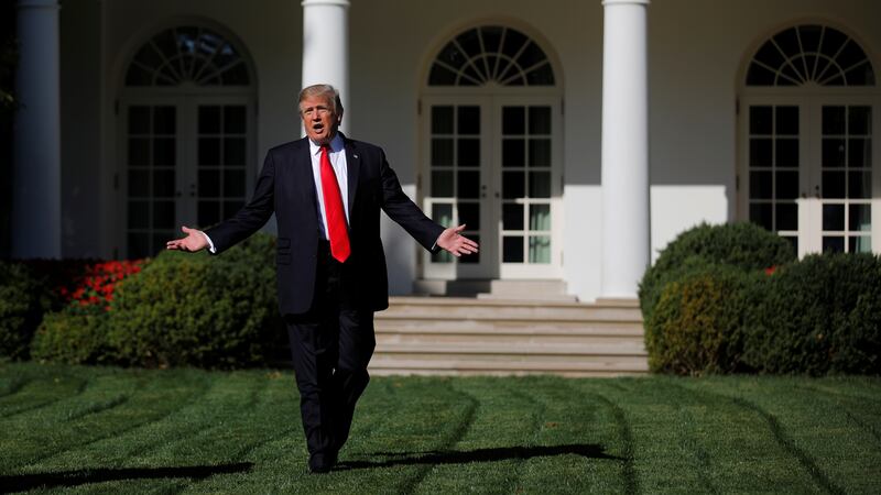 U.S. President Donald Trump talks to members of the press pool at the Rose Garden of the White House in Washington, U.S., September 15, 2017.