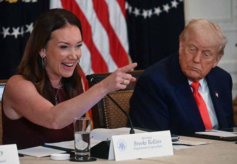 President Donald Trump (right) looks on as US Secretary of Agriculture Brooke Rollins speaks during a MAHA (Make America Healthy Again) Commission Event in the White House
